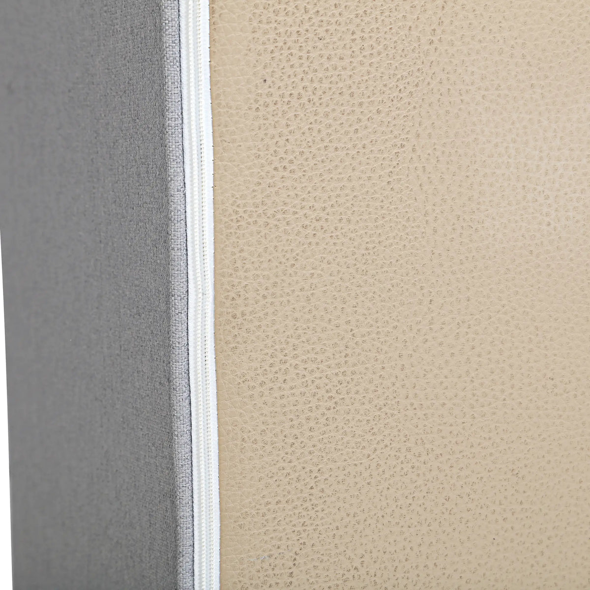 Gray armless chair edge with light piping and stitched seam detail