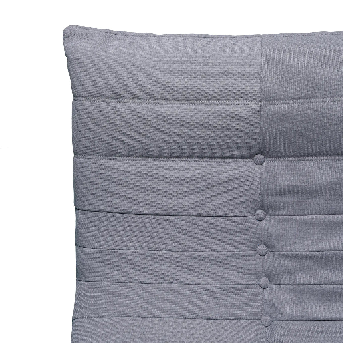 Gray chair back with tufted buttons and horizontal seam lines, plush compressed-foam style.