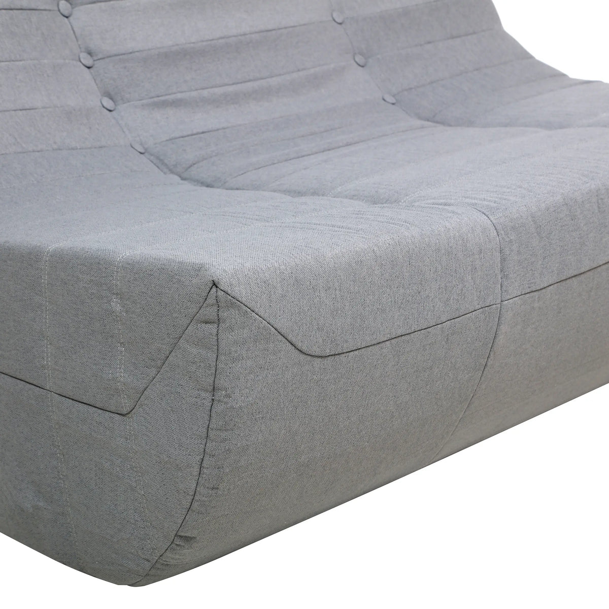 Gray compressed foam sofa armrest and seat cushion with stitched seams