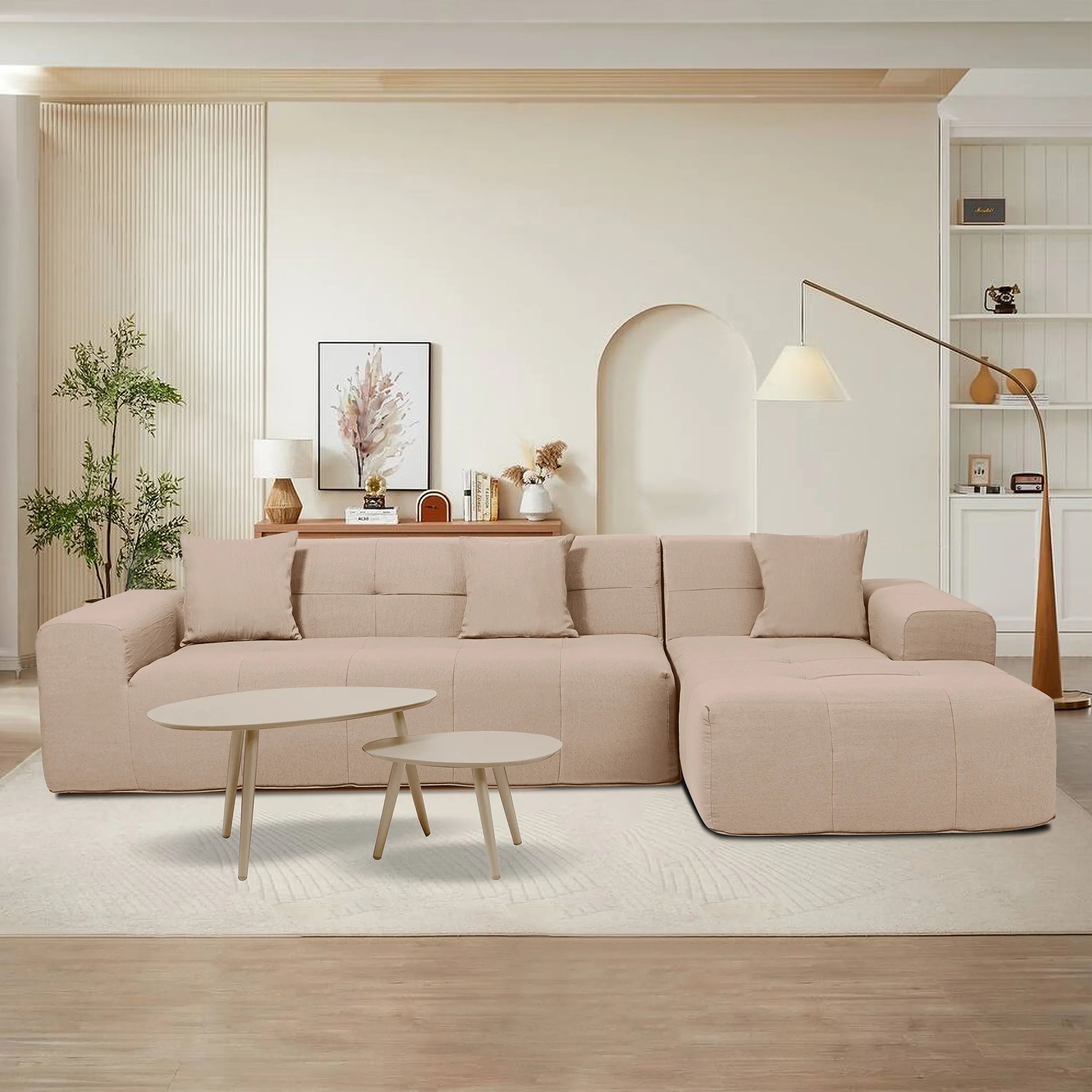 Tan sectional sofa set with round nesting tables in a living room