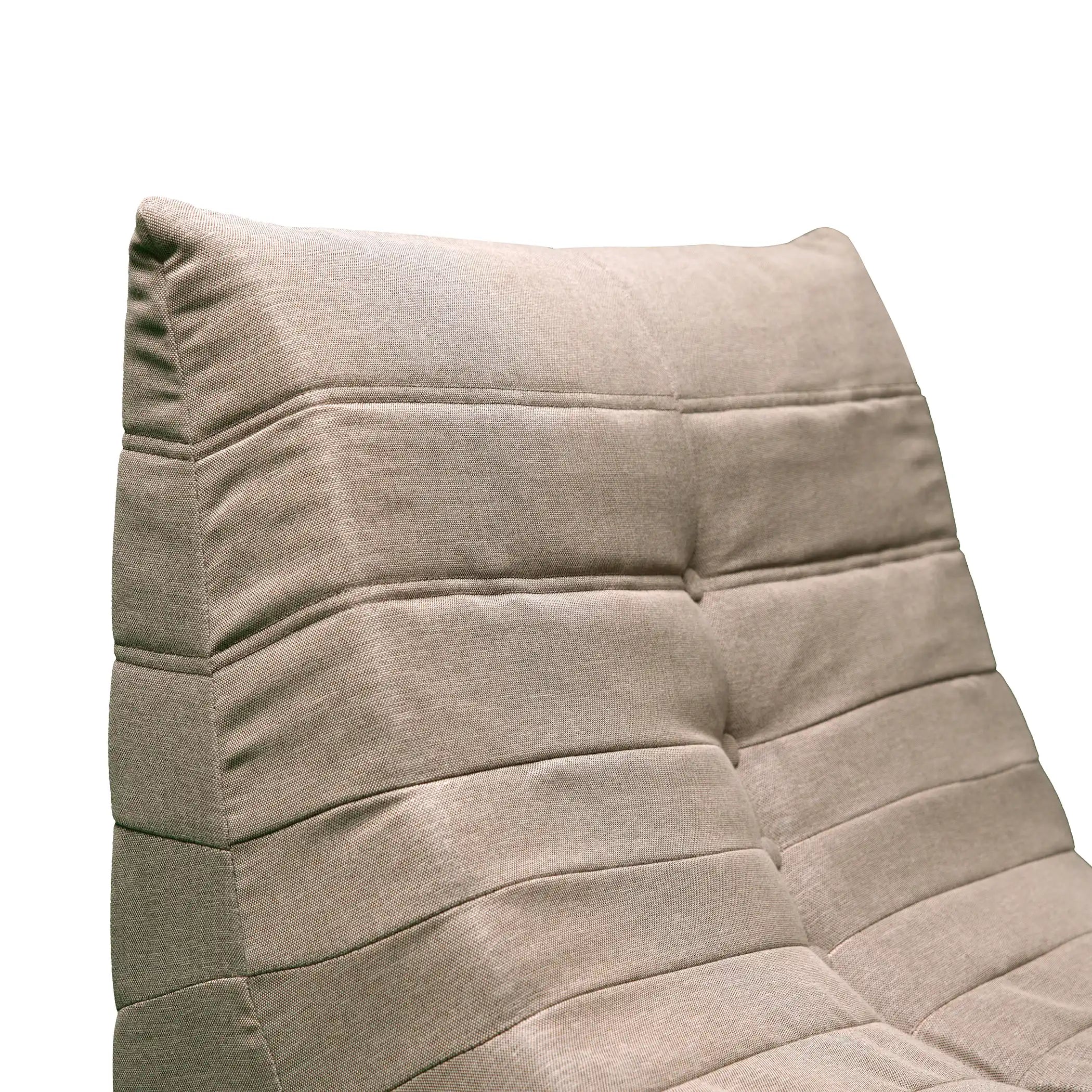 Compressed foam armchair, taupe-brown fabric with tufted cushion seams and curved arms