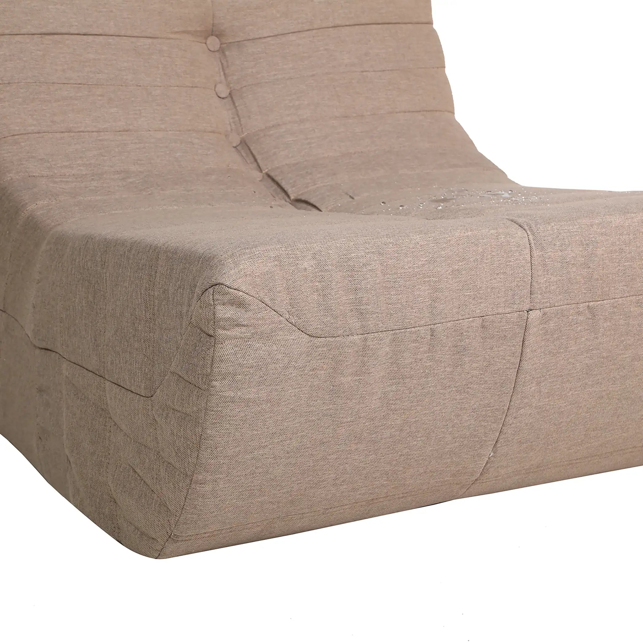Close-up of taupe-brown upholstered armchair arm and seat seam stitching
