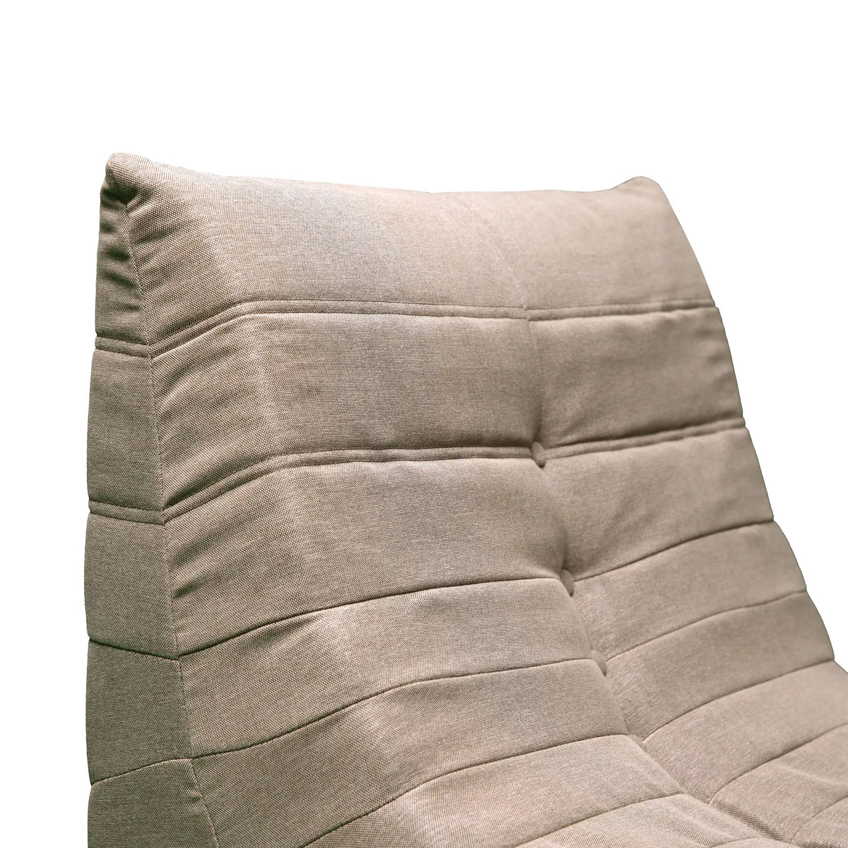 Tan upholstered foam chair back with tufted seams and cushioned panels