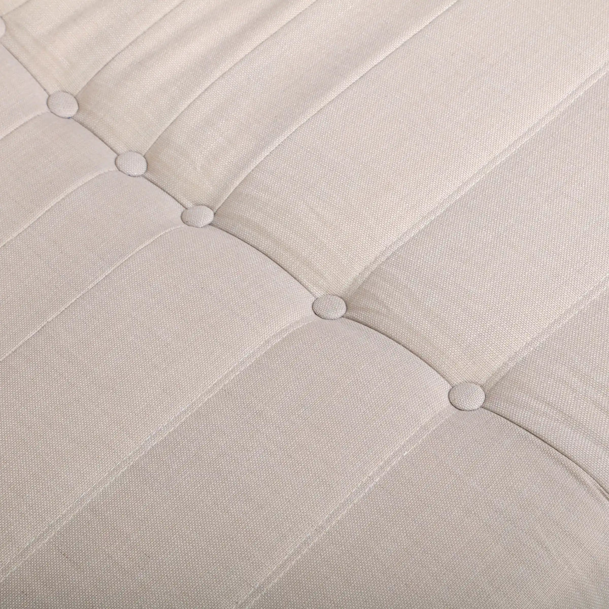 Beige fabric loveseat chair back with tufted button accents and curved stitching