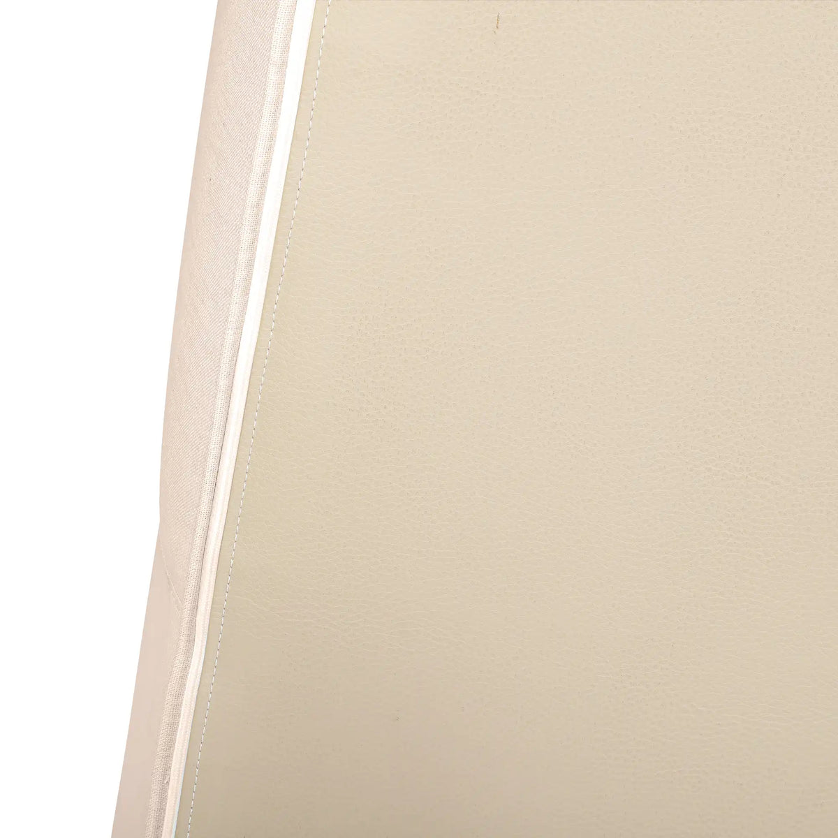 Beige compressed foam chair cushion side with stitched seam edging