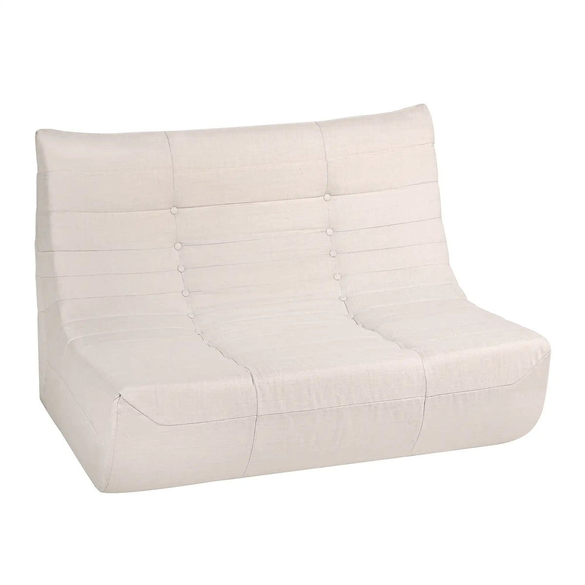Beige compressed-foam sofa with tufted buttons and curved seat cushion.