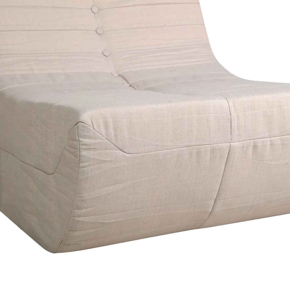 Beige sofa arm and seat with button-tufted back and stitched cushion edges.