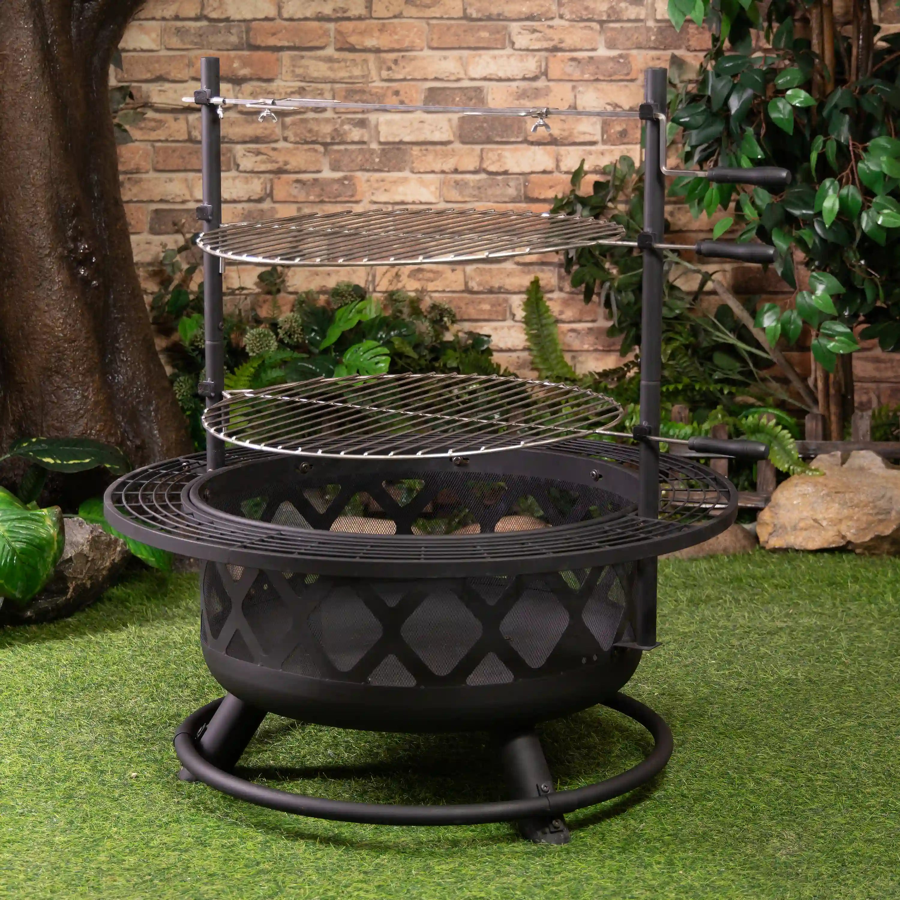 Outdoor steel fire pit grill with raised upper and lower grates, rotisserie support frame