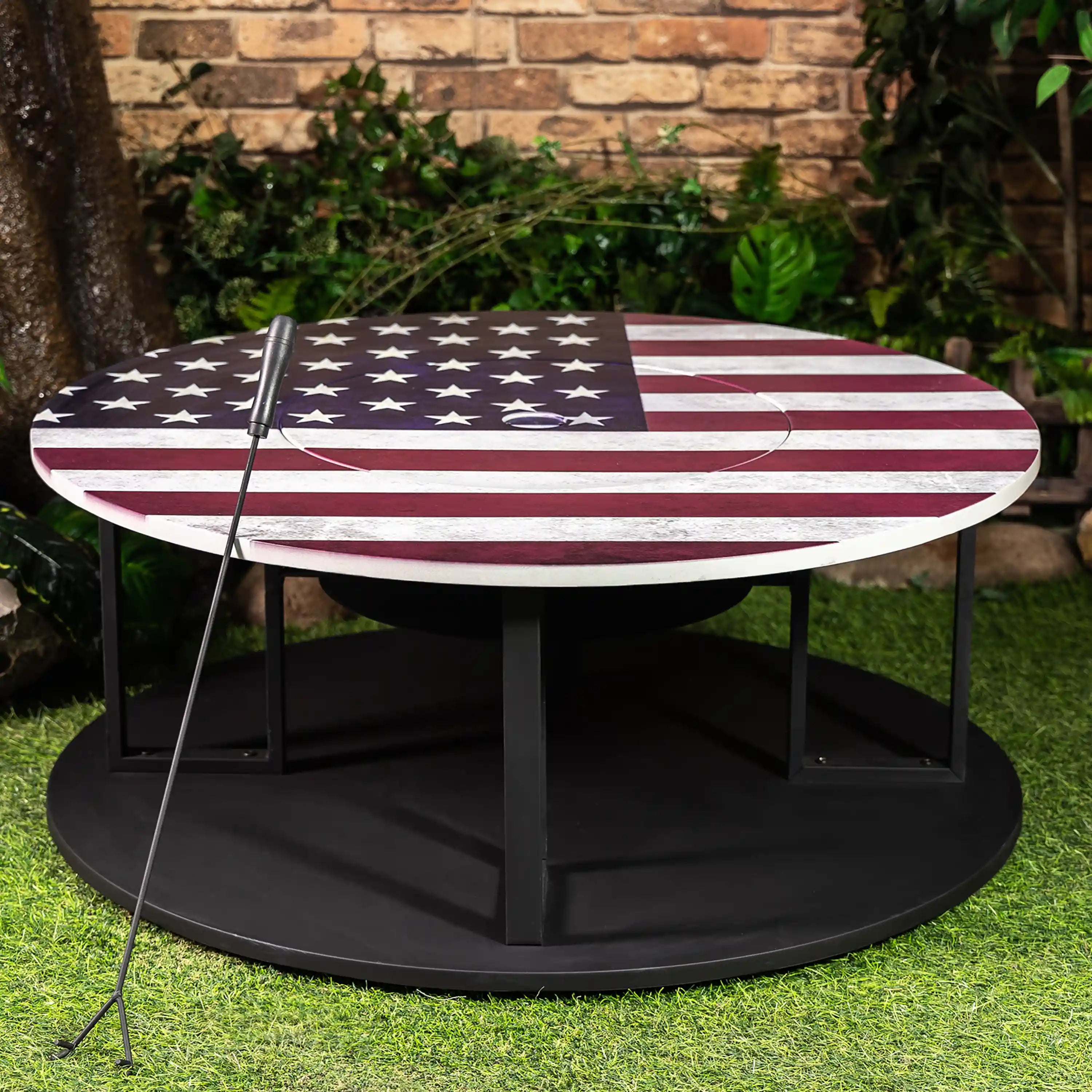 Outdoor star-and-stripe fire pit on black base with log storage and poker tool