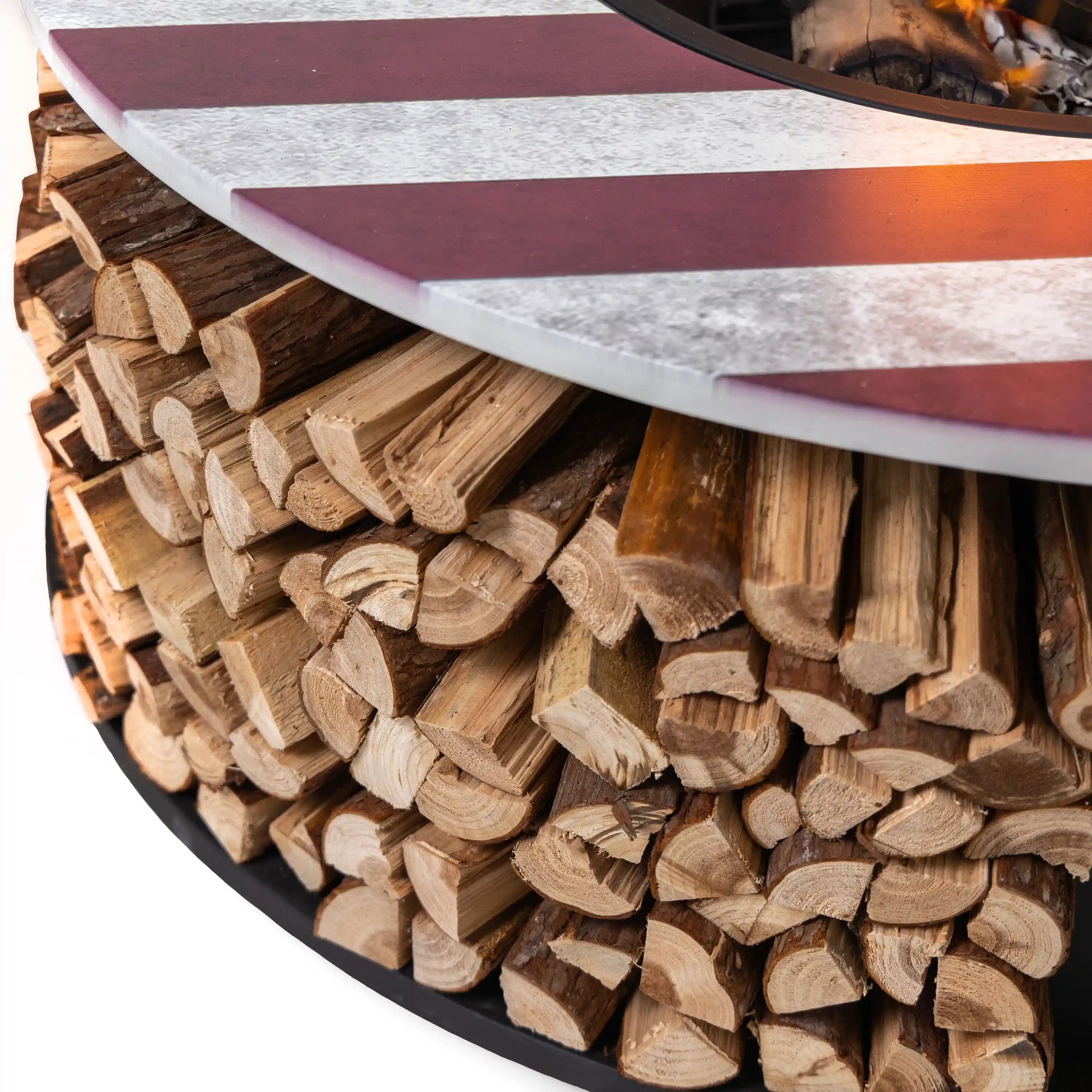 Close-up of split firewood stored in the black log bin under the rim
