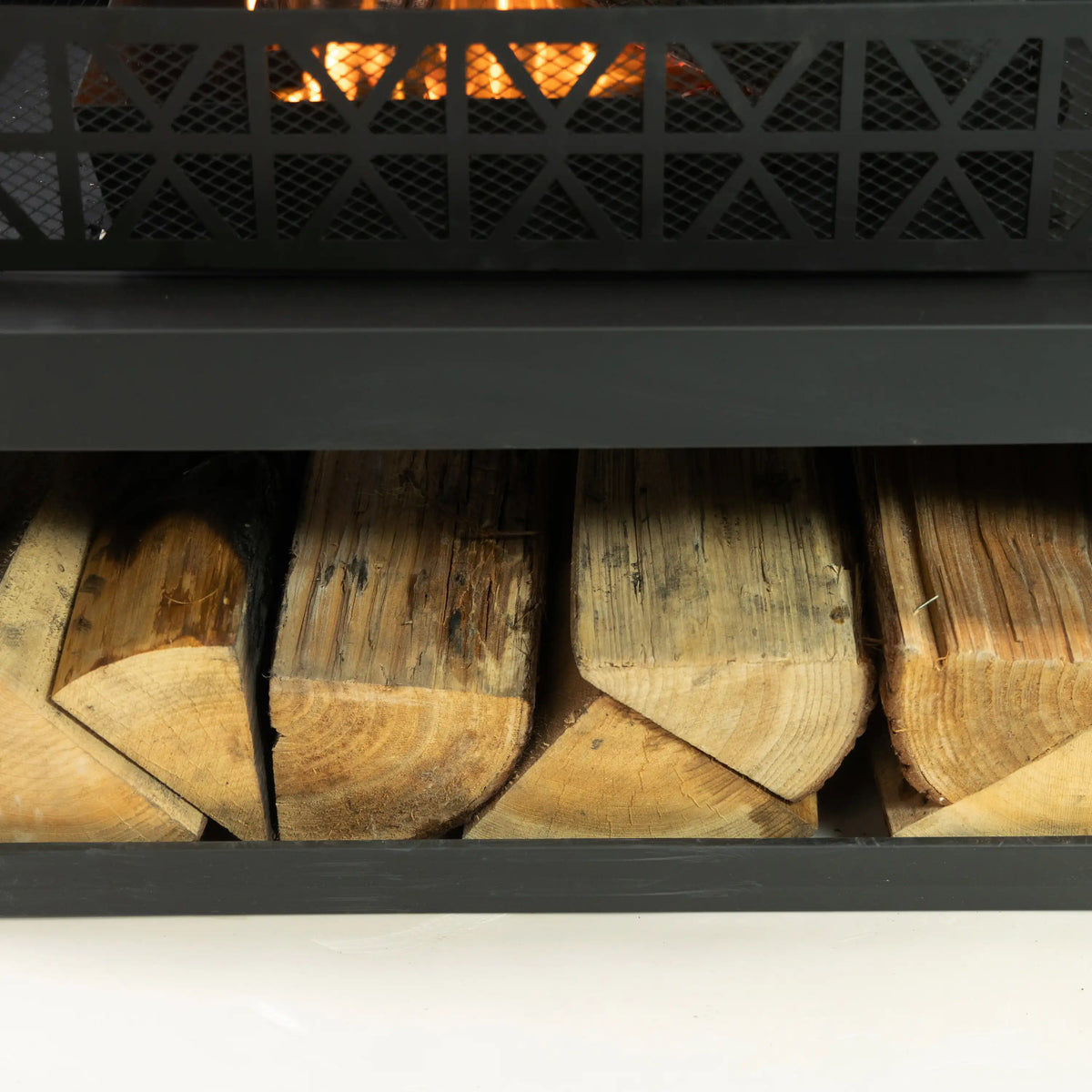 Outdoor fireplace log storage compartment with stacked split firewood