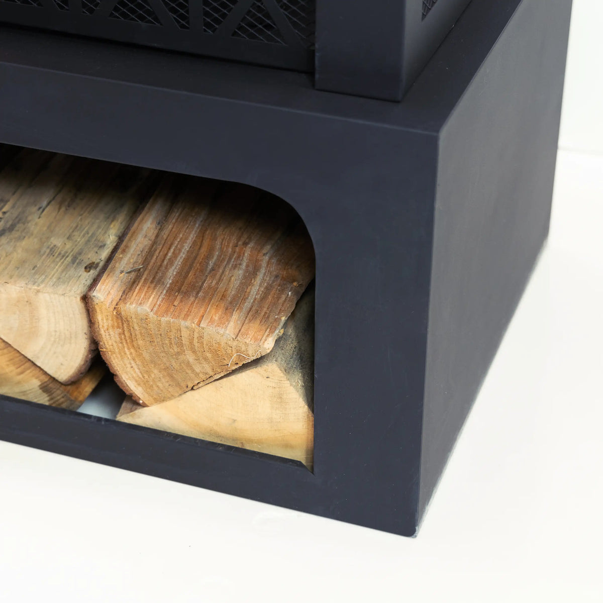 Outdoor fireplace log storage view with split firewood inside dark charcoal body