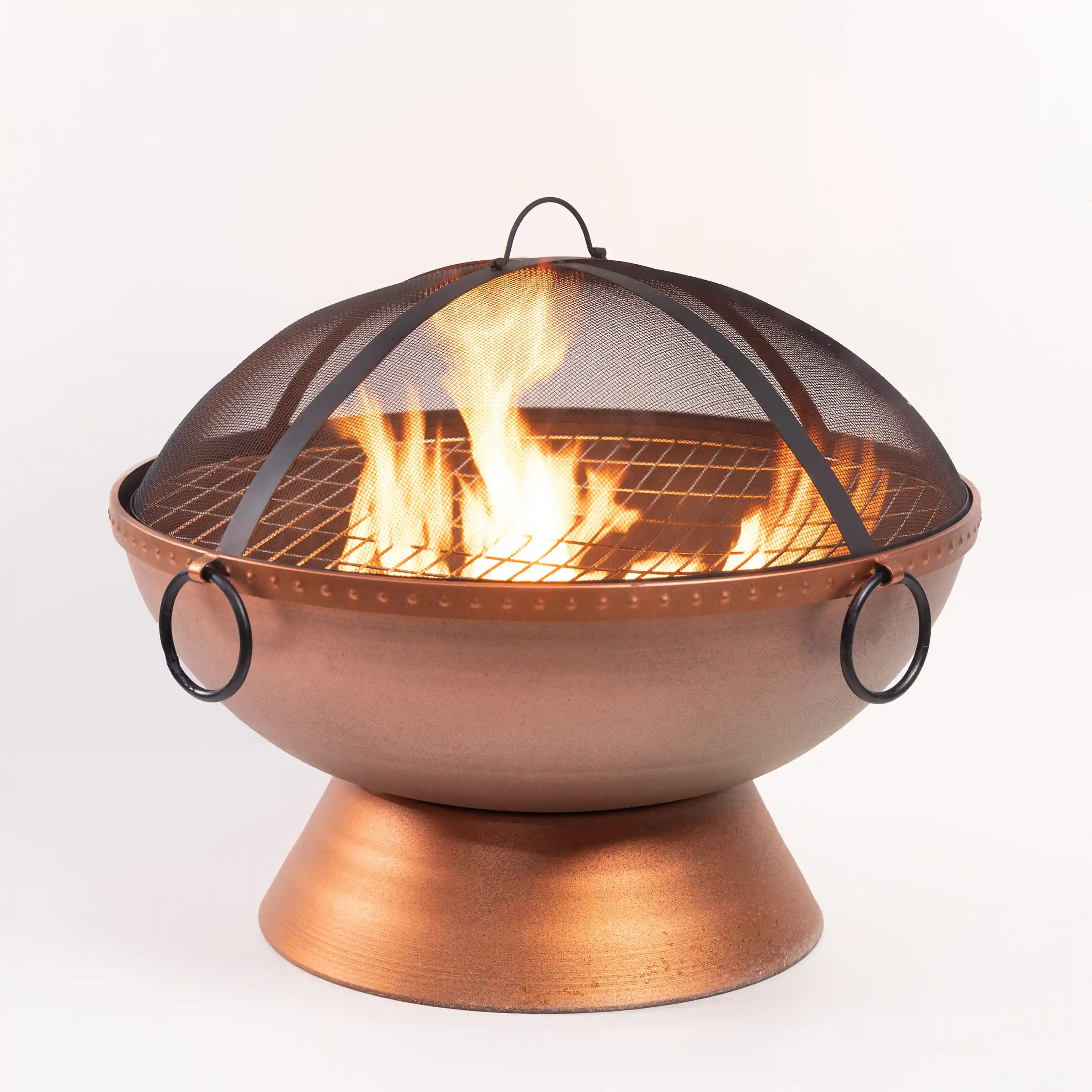 Bronze-toned round firepit with curved mesh top and side handles, active flames