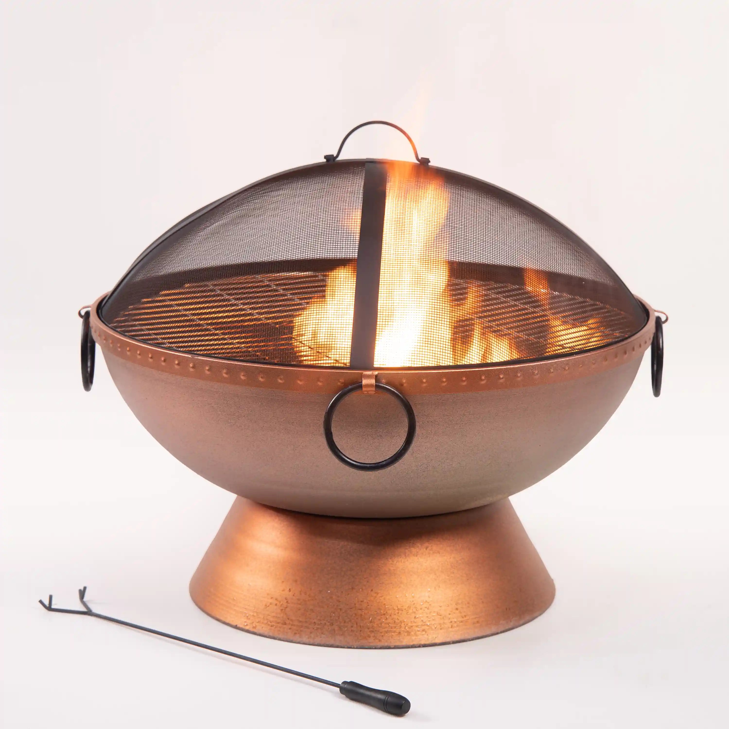 Round outdoor steel firepit with mesh spark screen and side handles, flames inside