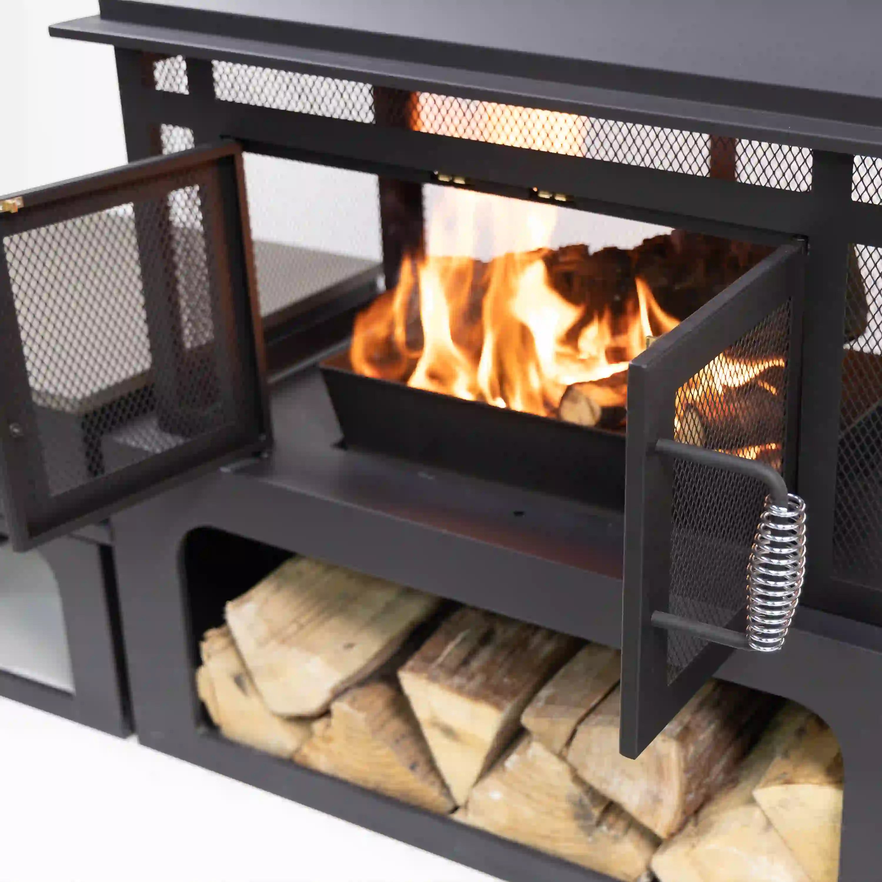 Outdoor rectangular steel wood-burning fireplace with open log storage compartment and mesh panels