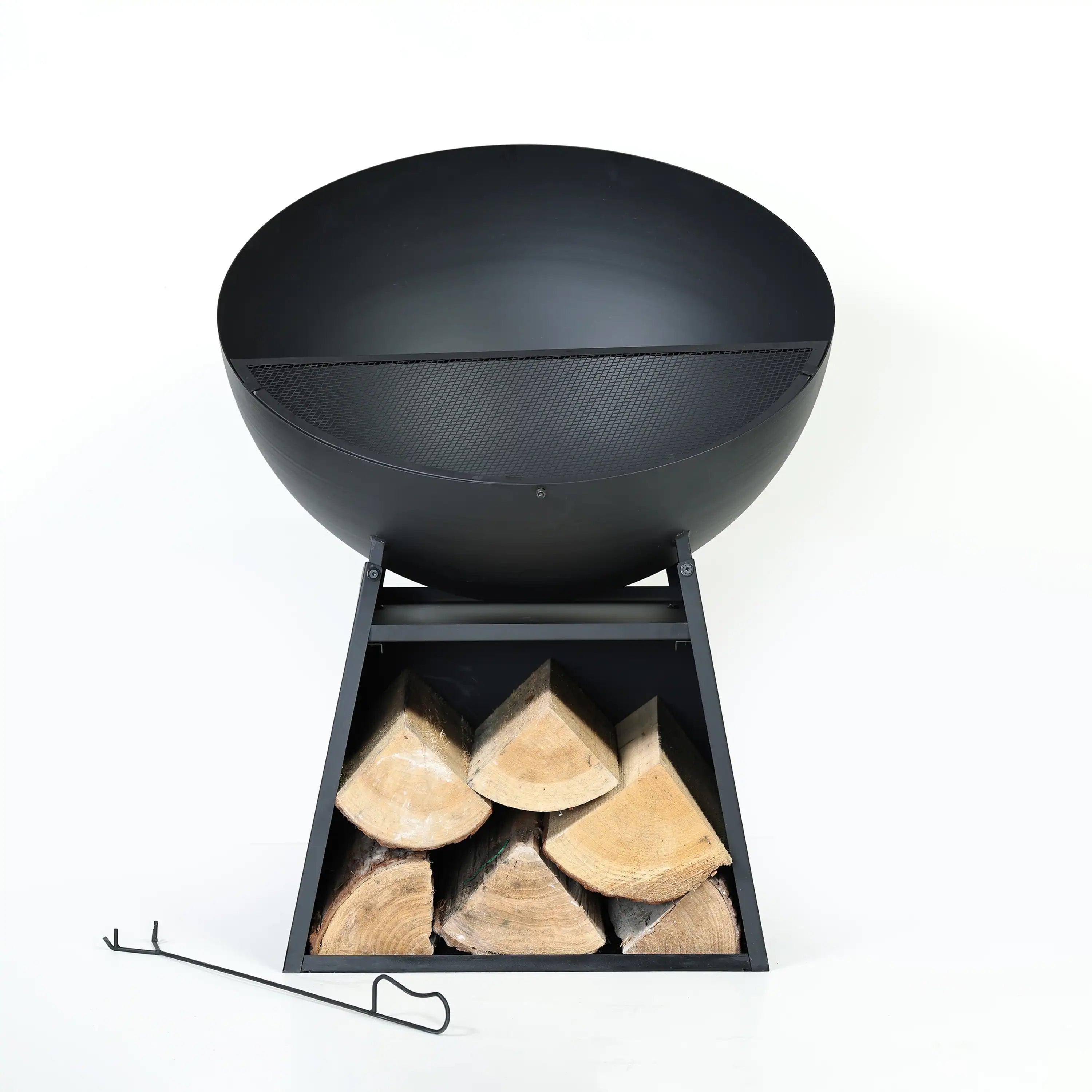 Black round fire pit with spark screen and stacked firewood in the front compartment.