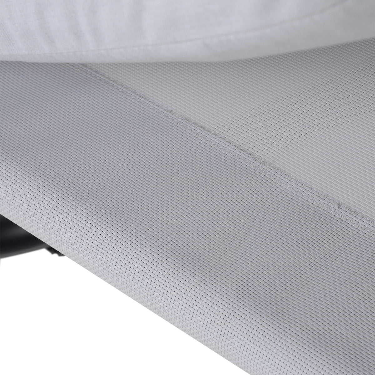 Close-up of light gray hammock daybed fabric texture with stitched seam line