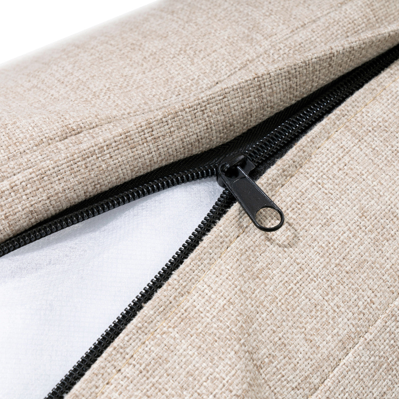 Beige fabric cushion with black zipper detail on patio chair