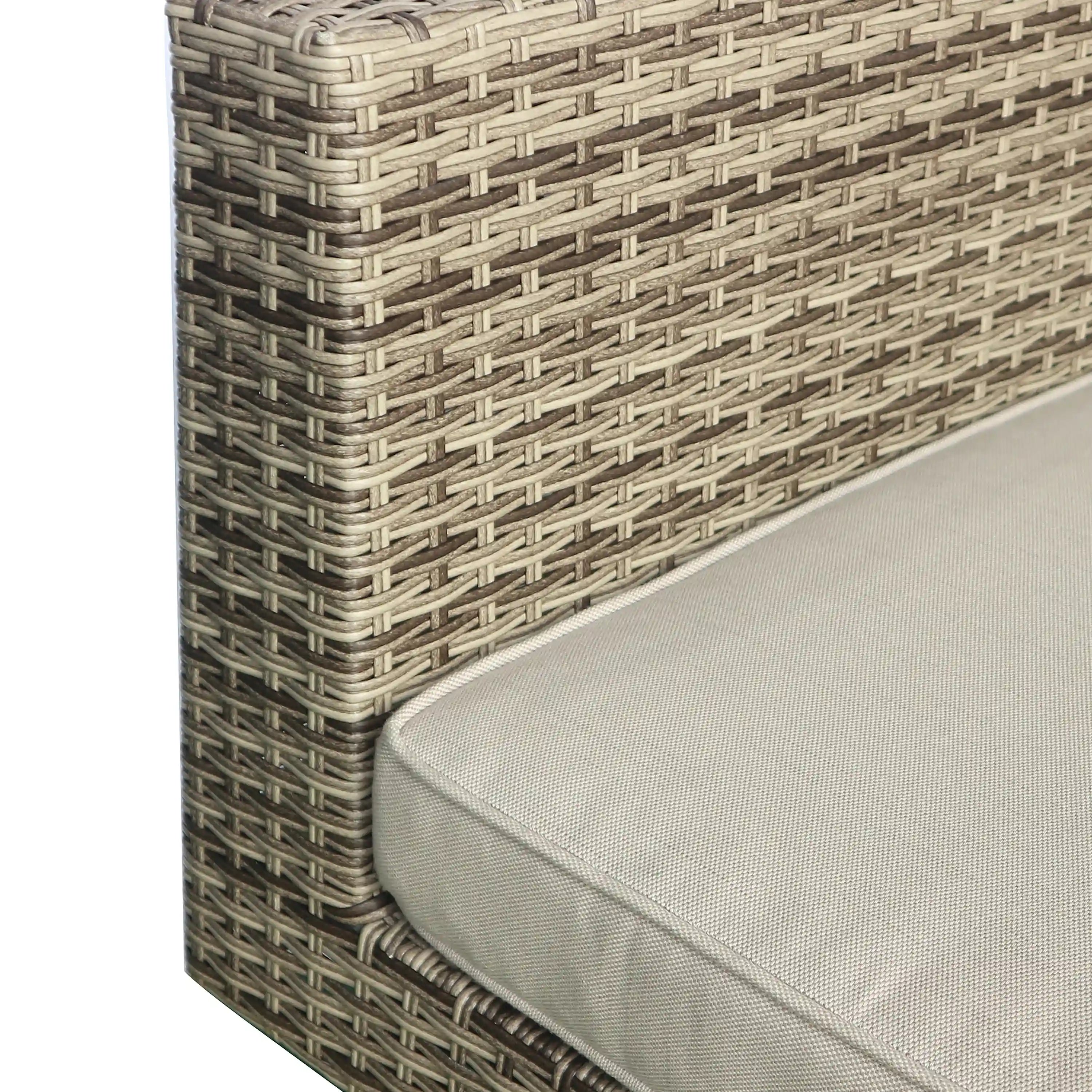 Close-up of gray wicker weave corner with beige cushion edge on a black metal base