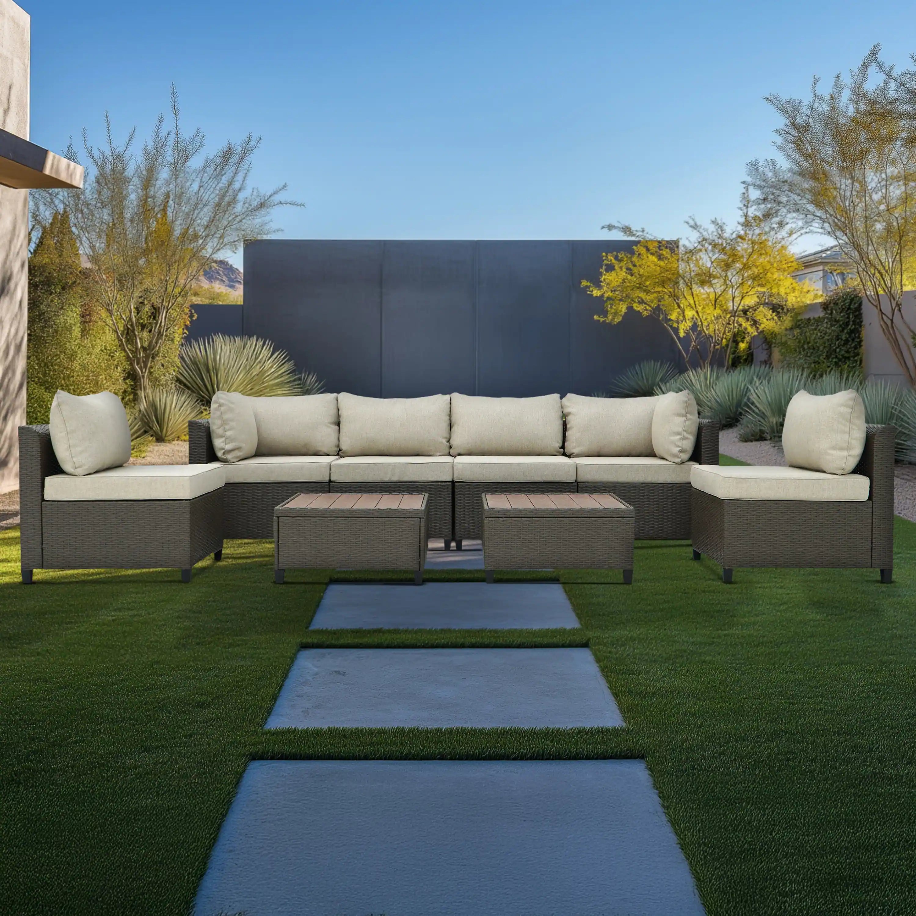 Outdoor sectional wicker sofa set with beige seat and back cushions and two ottoman tables