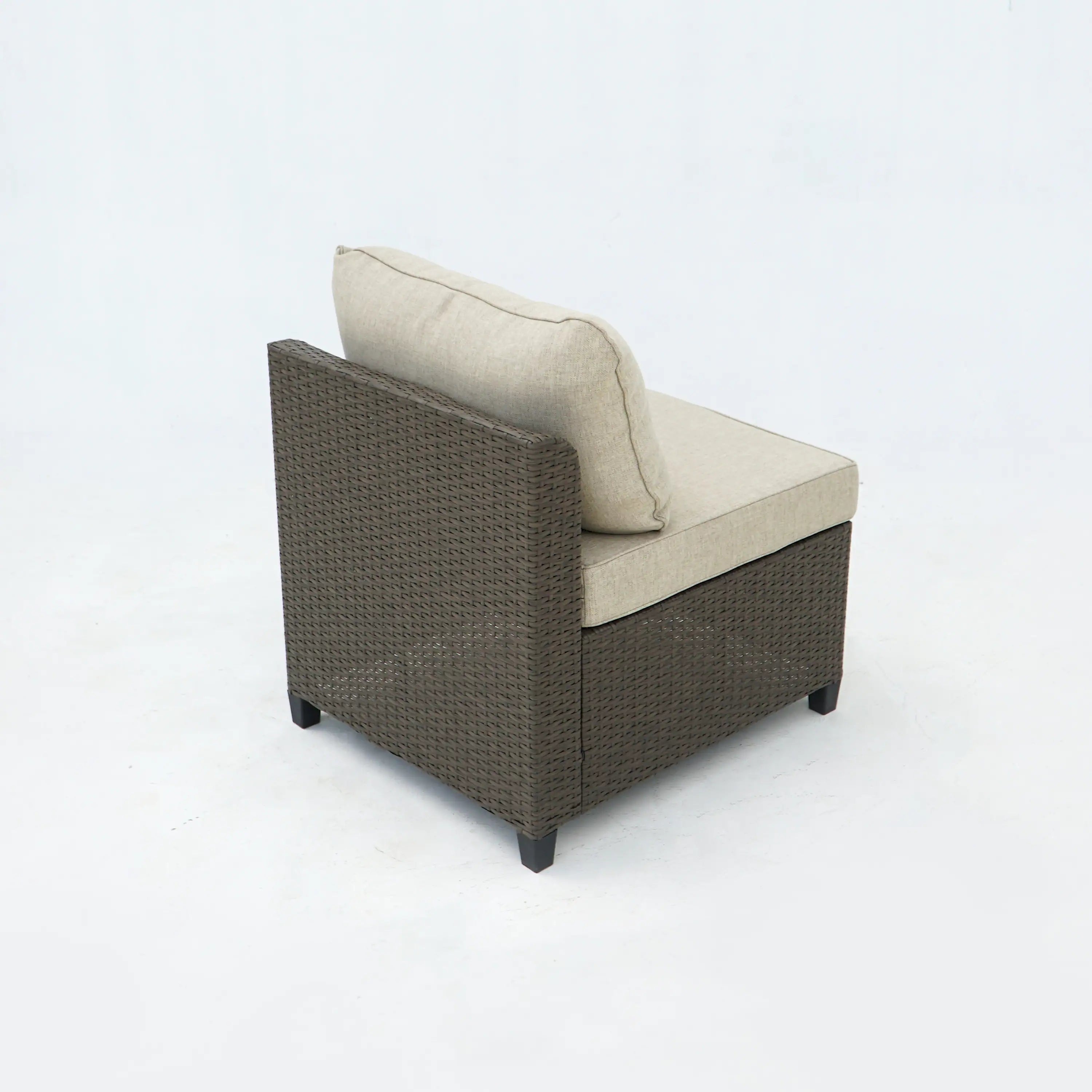 Outdoor wicker accent chair with light beige cushions and dark frame