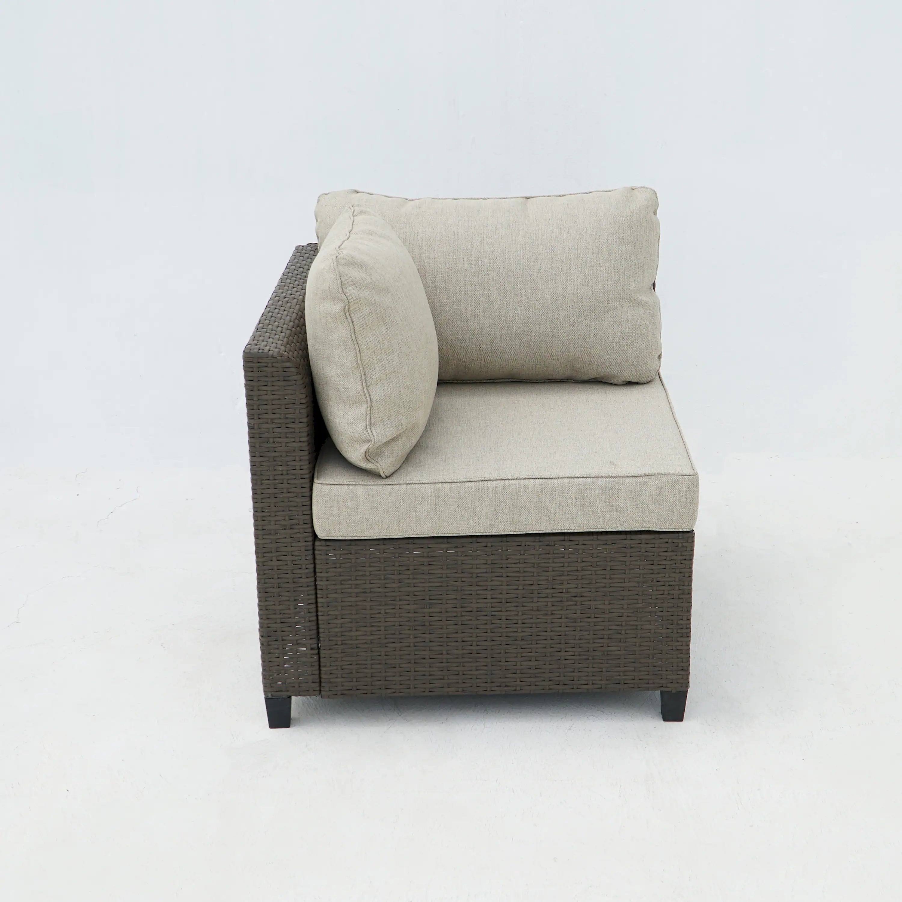 Outdoor wicker armchair with light beige seat and lumbar cushions