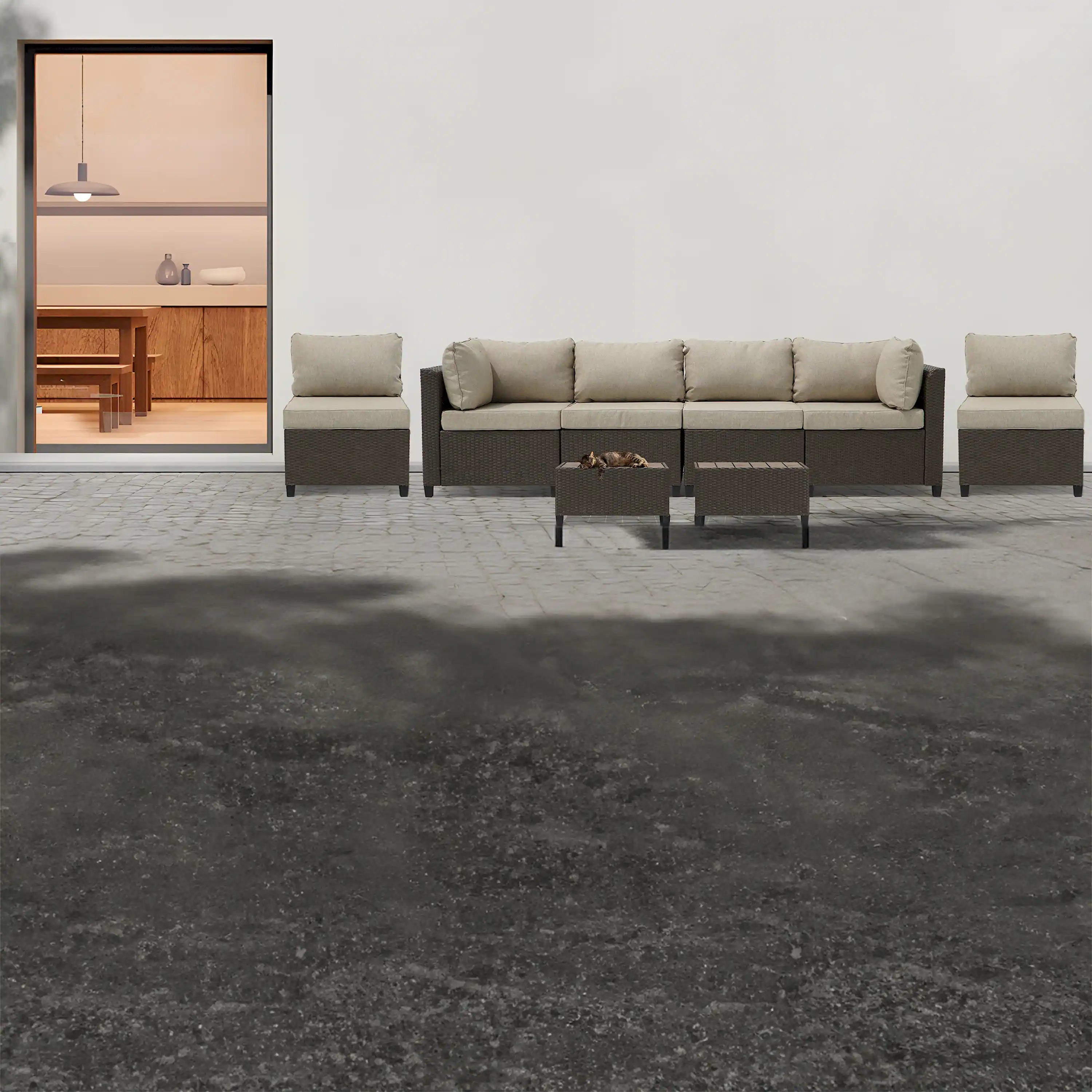Outdoor wicker sectional sofa set with beige cushions and matching ottoman tables