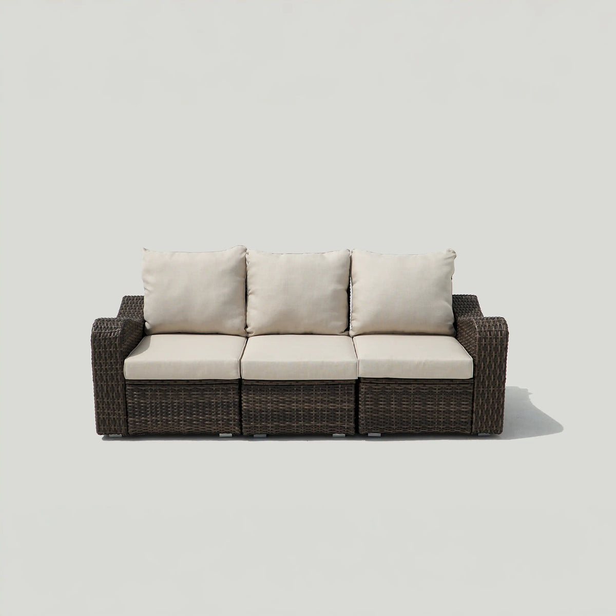 Brown outdoor wicker 3-seat sofa with beige cushions and three back pillows