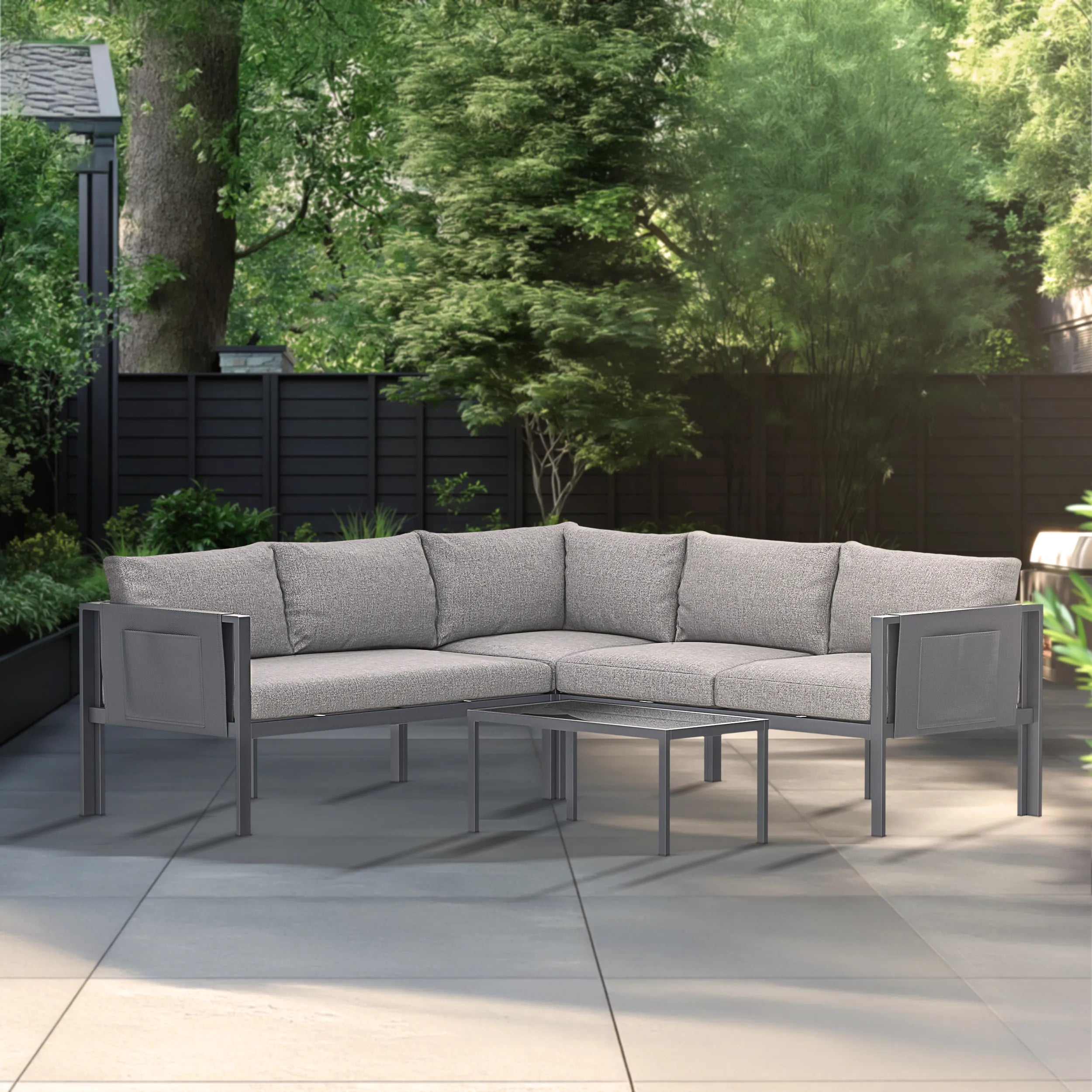 Gray outdoor sectional sofa set with glass-top table and cushioned seat cushions