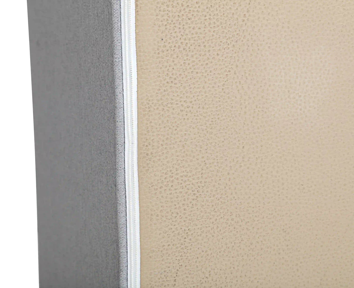 Gray fabric armrest seam detail with textured weave and stitched edge