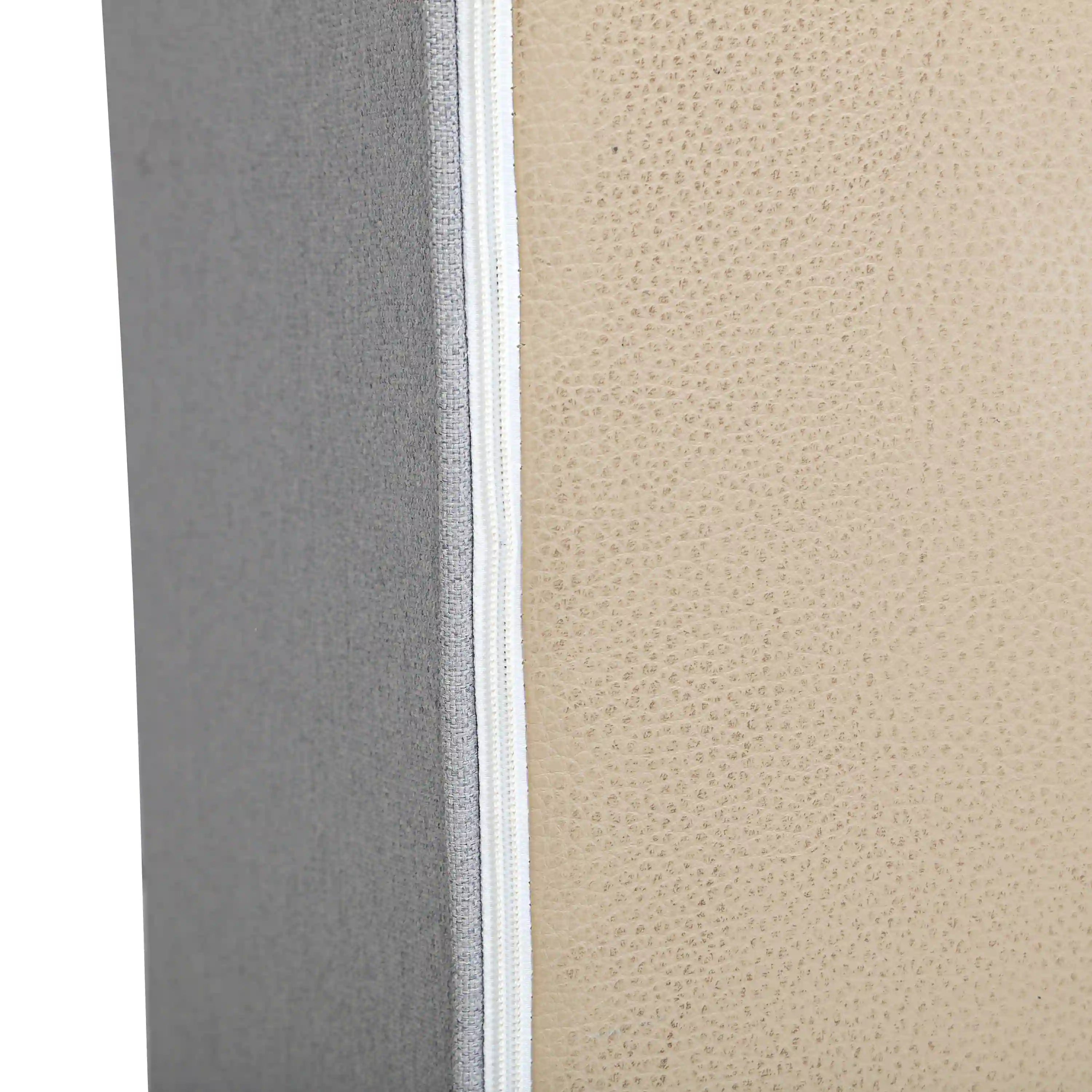 Gray outdoor cushion edge with visible zipper trim and fabric seam