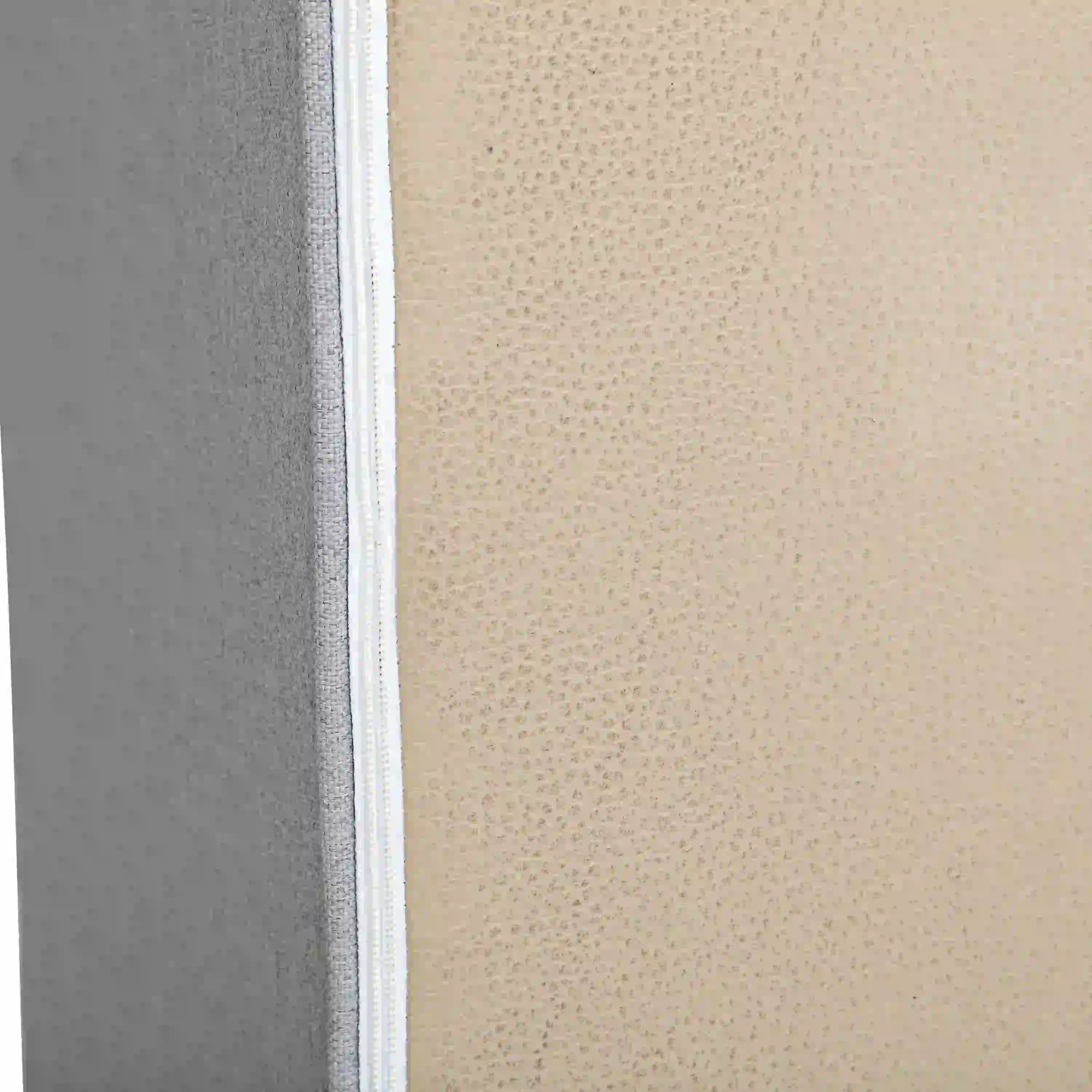 Gray chair arm panel close-up with textured fabric and white seam stitching