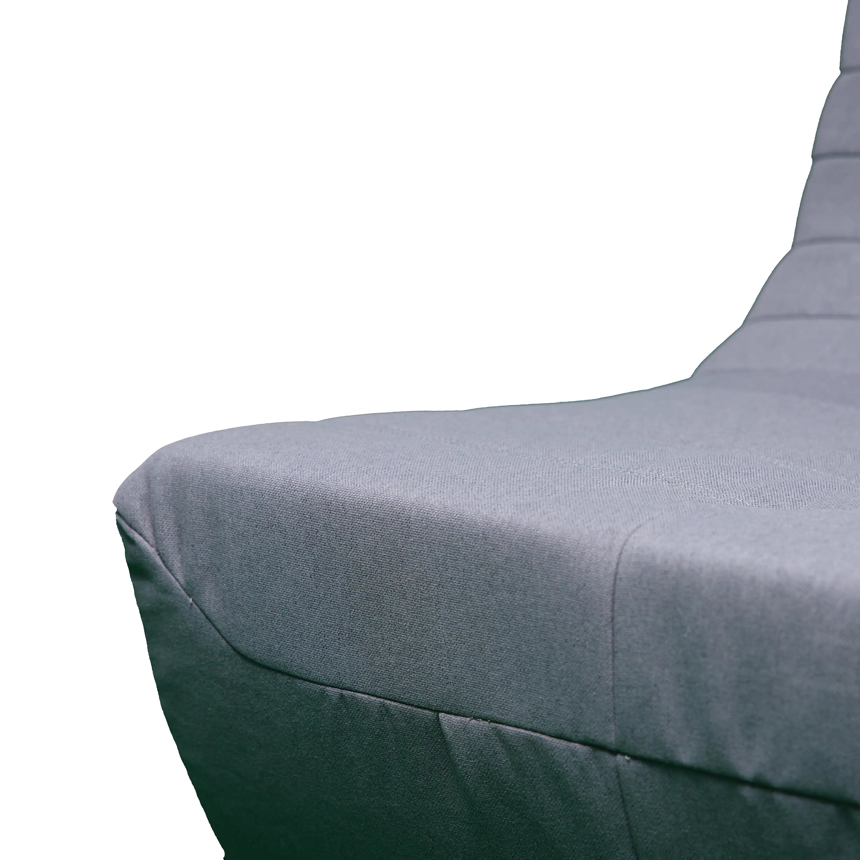Gray outdoor compressed foam chair cushion with angled armrest and stitched seam