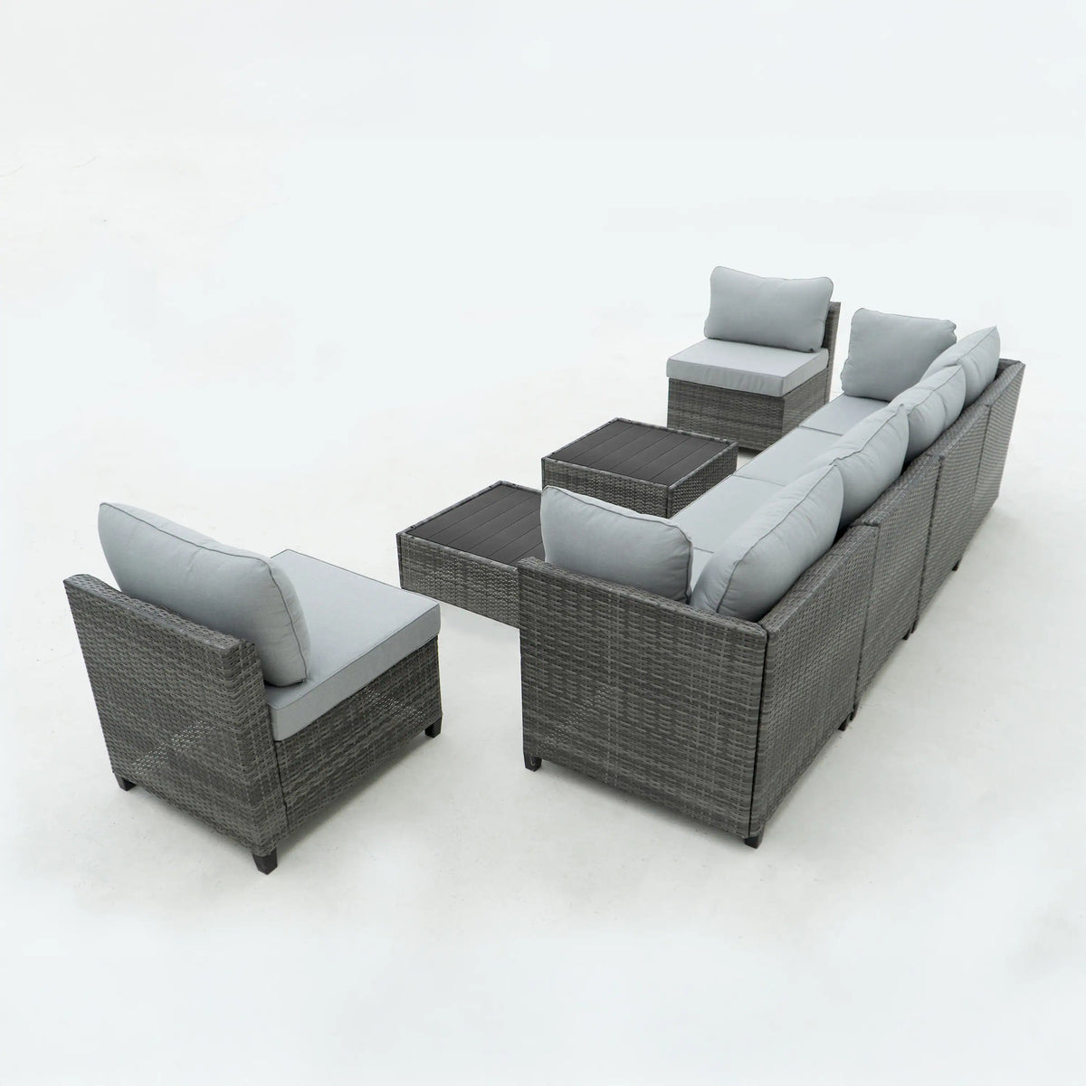 Gray outdoor wicker sectional sofa with light gray cushions and two side tables