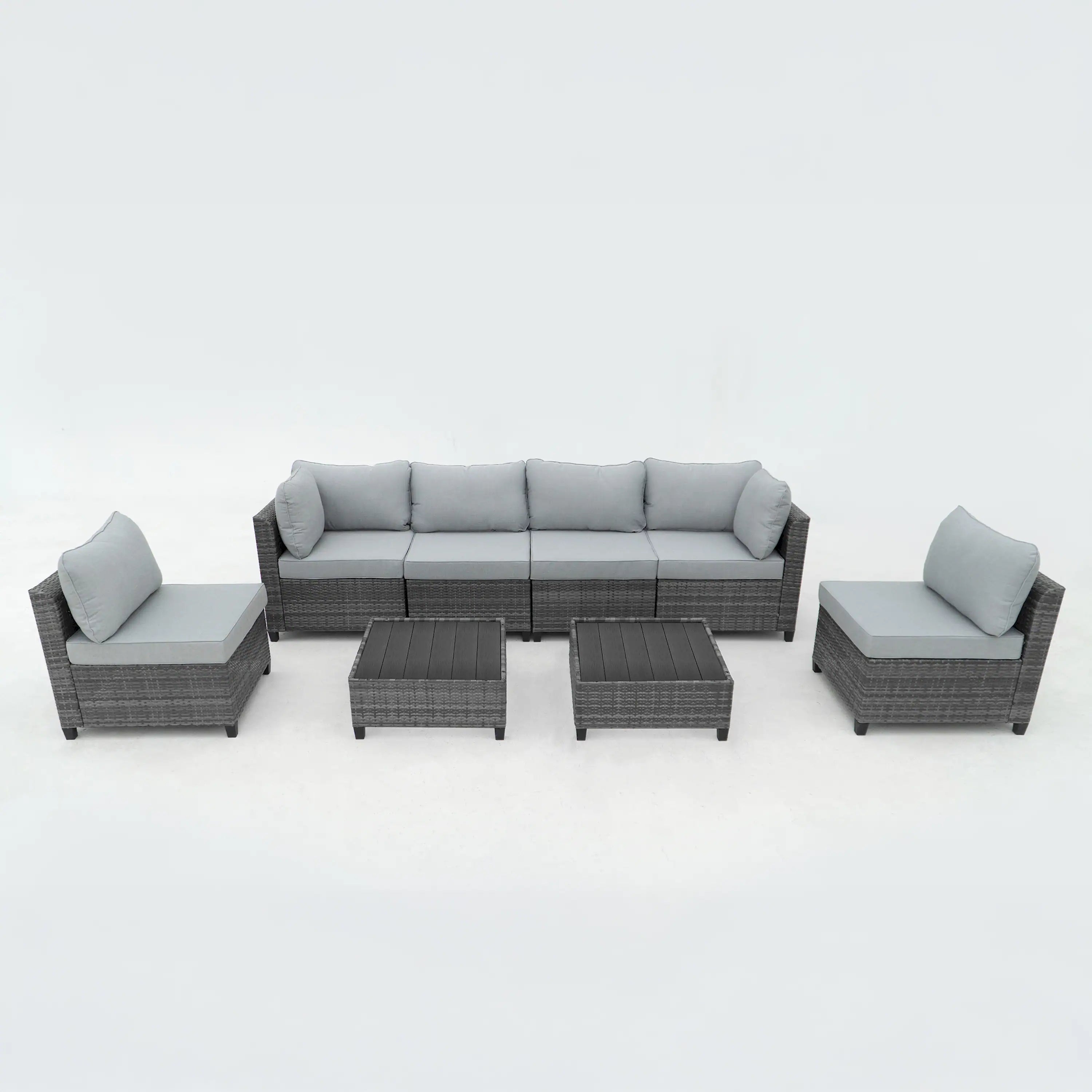 Gray outdoor sectional sofa set with light gray cushions, ottomans, and side tables