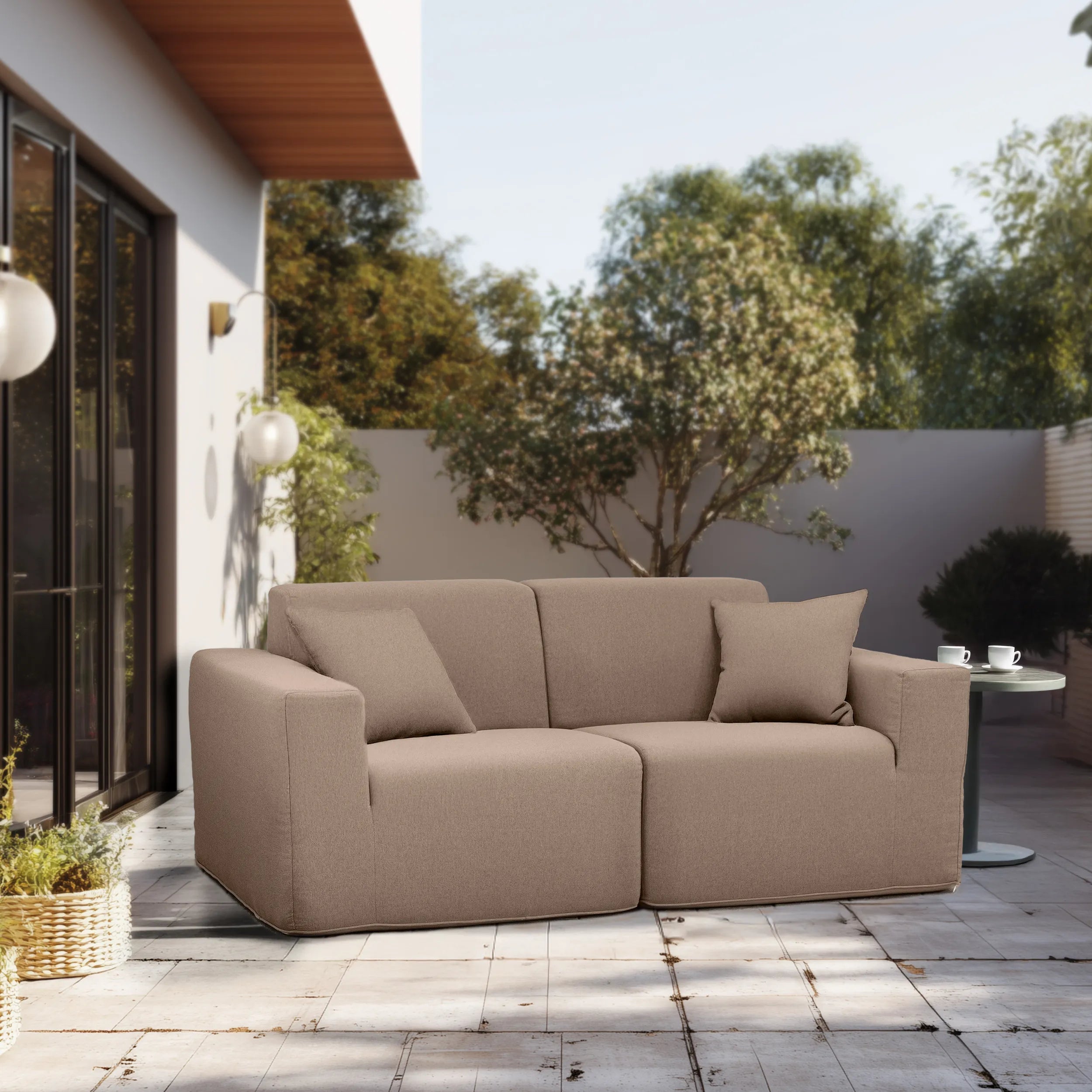 Taupe outdoor two-piece sectional sofa with throw pillows and wide seat
