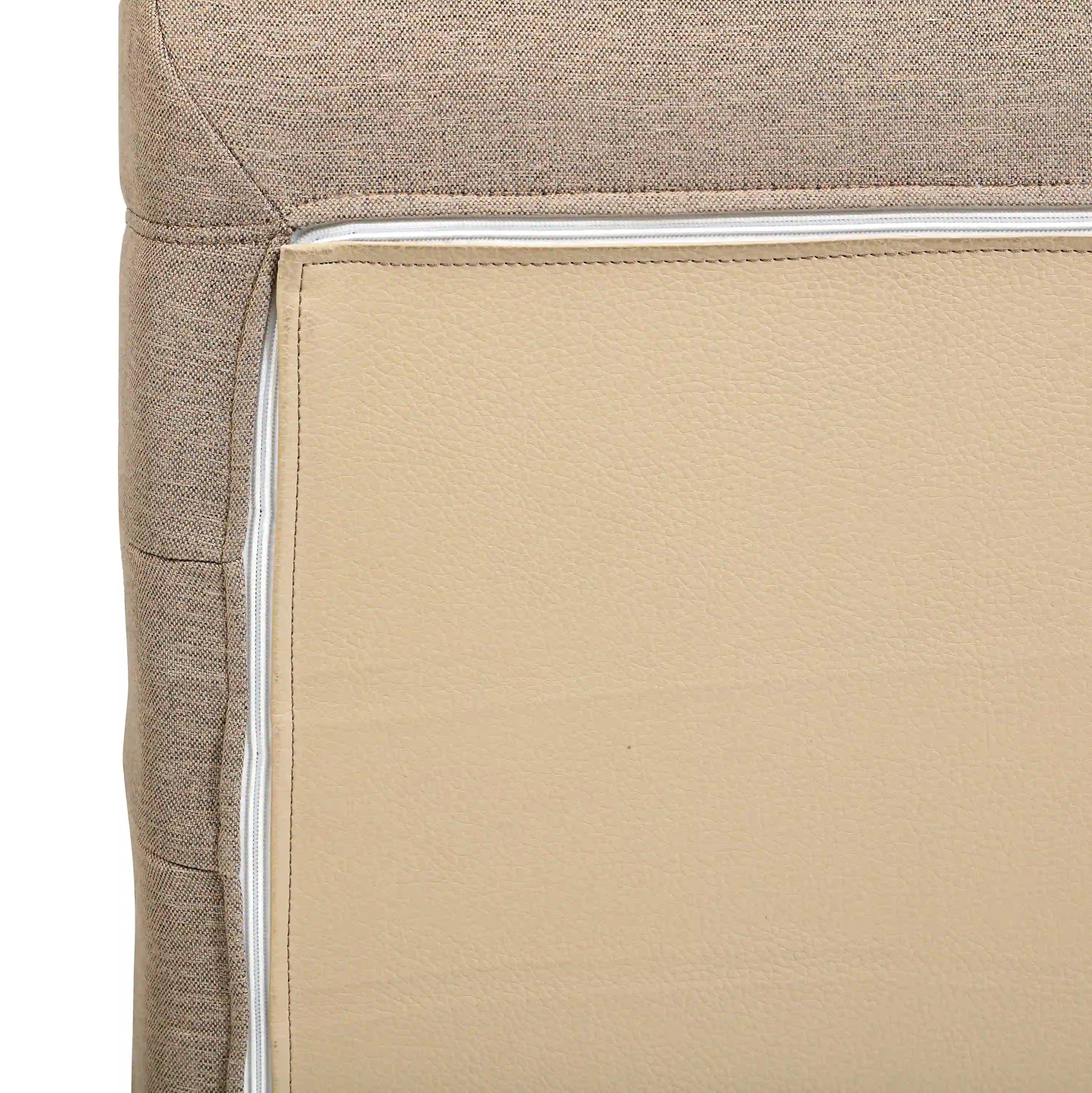 Outdoor loveseat sofa chair, corner view of padded cushion with stitched border
