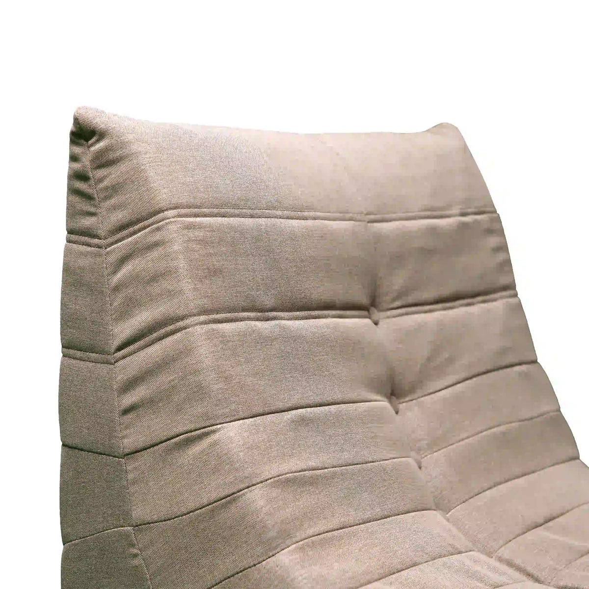 Outdoor compressed foam chair, light beige fabric with tufted back and padded arms.