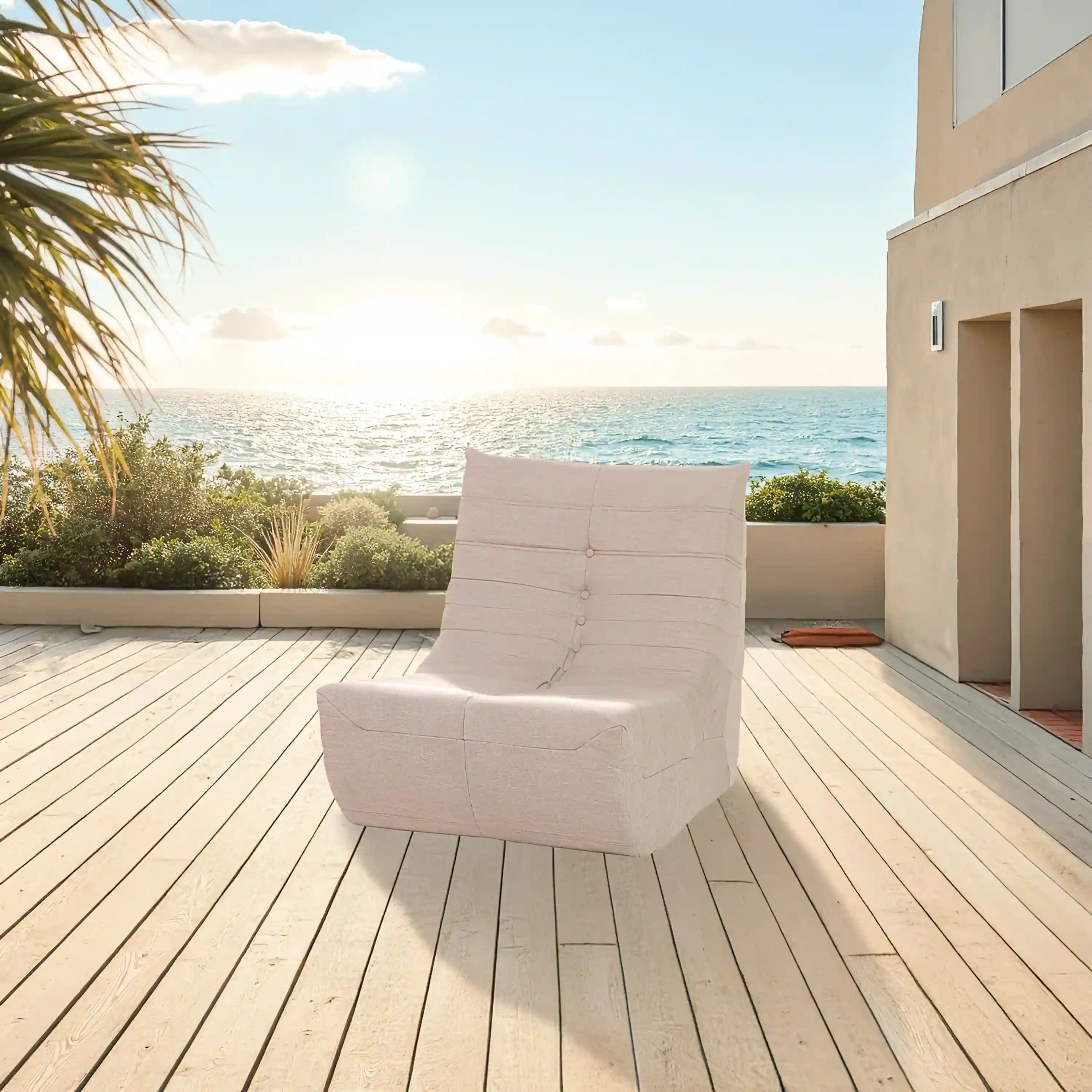 Outdoor compressed foam armchair, light beige seat with button-tufted back and armrests.