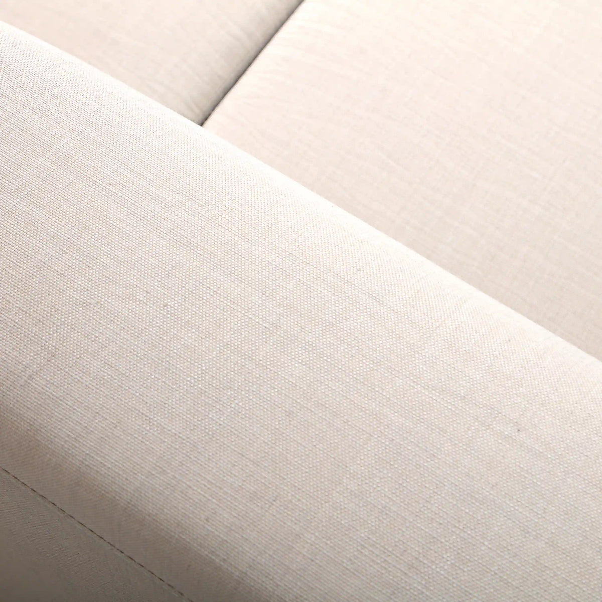 Beige upholstered seat cushion with textured fabric close-up
