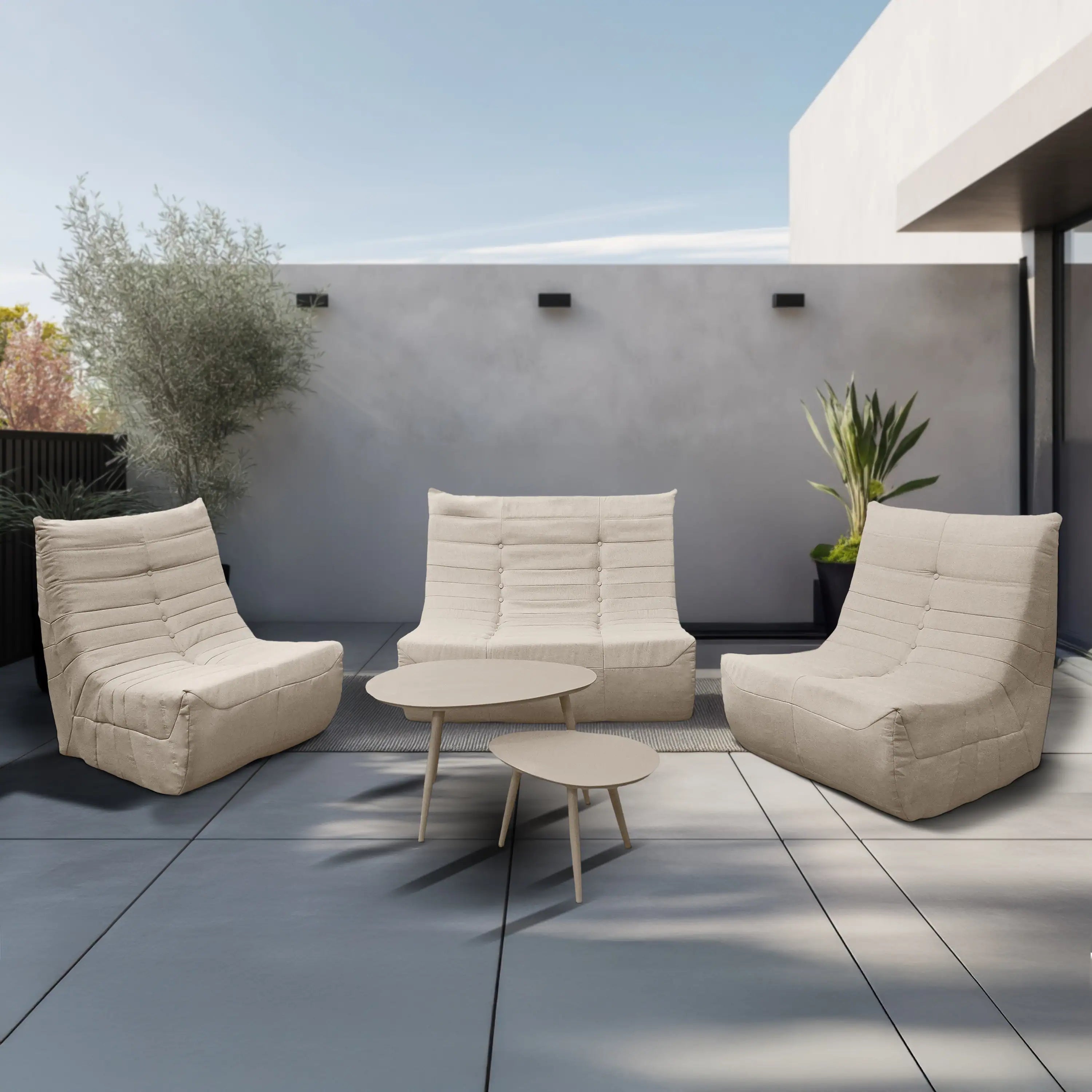 Beige outdoor foam loveseat sofa set with two chairs and small round coffee table
