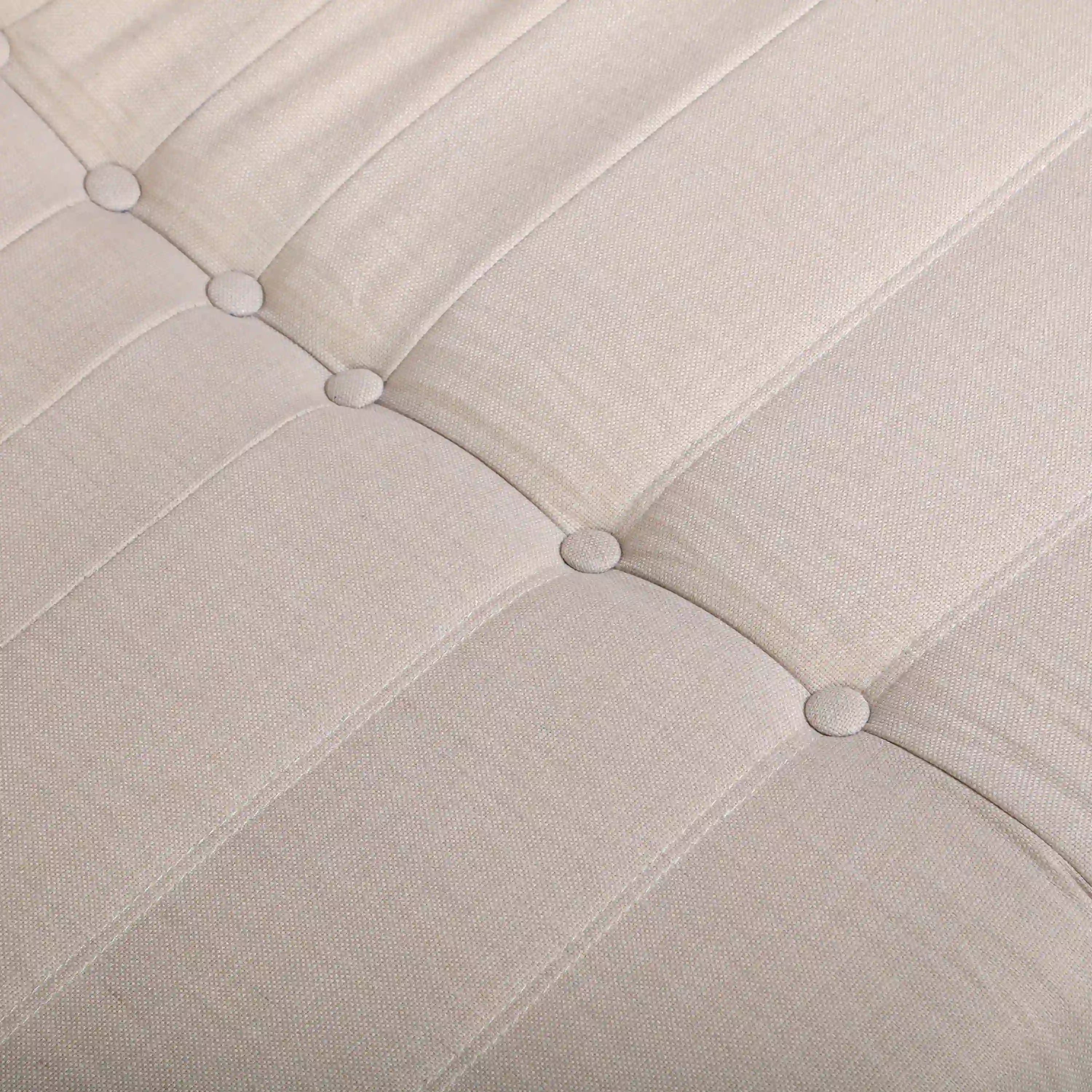 Beige tufted seat cushion with button detail and stitched channel seams on chair back