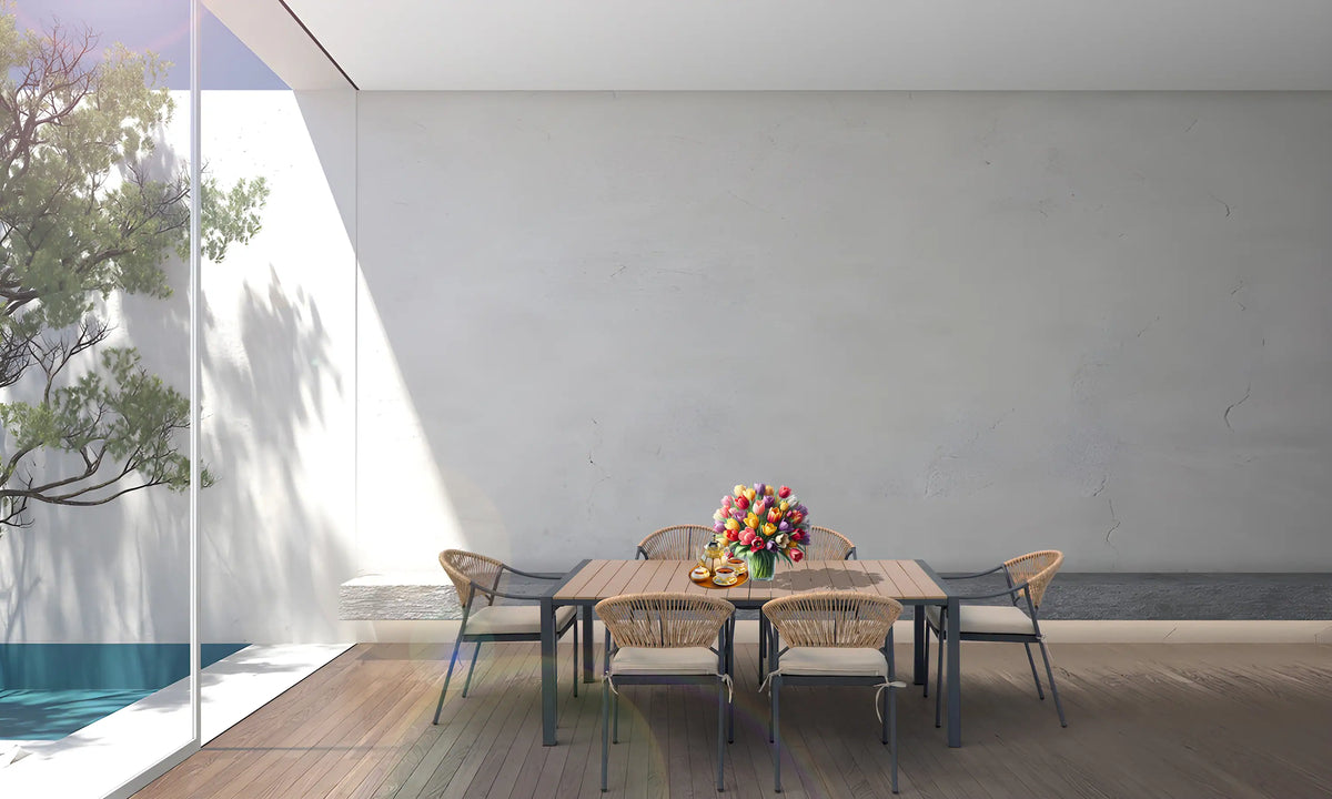 Outdoor dining set with wood-slat table, six wicker chairs, and beige seat cushions.