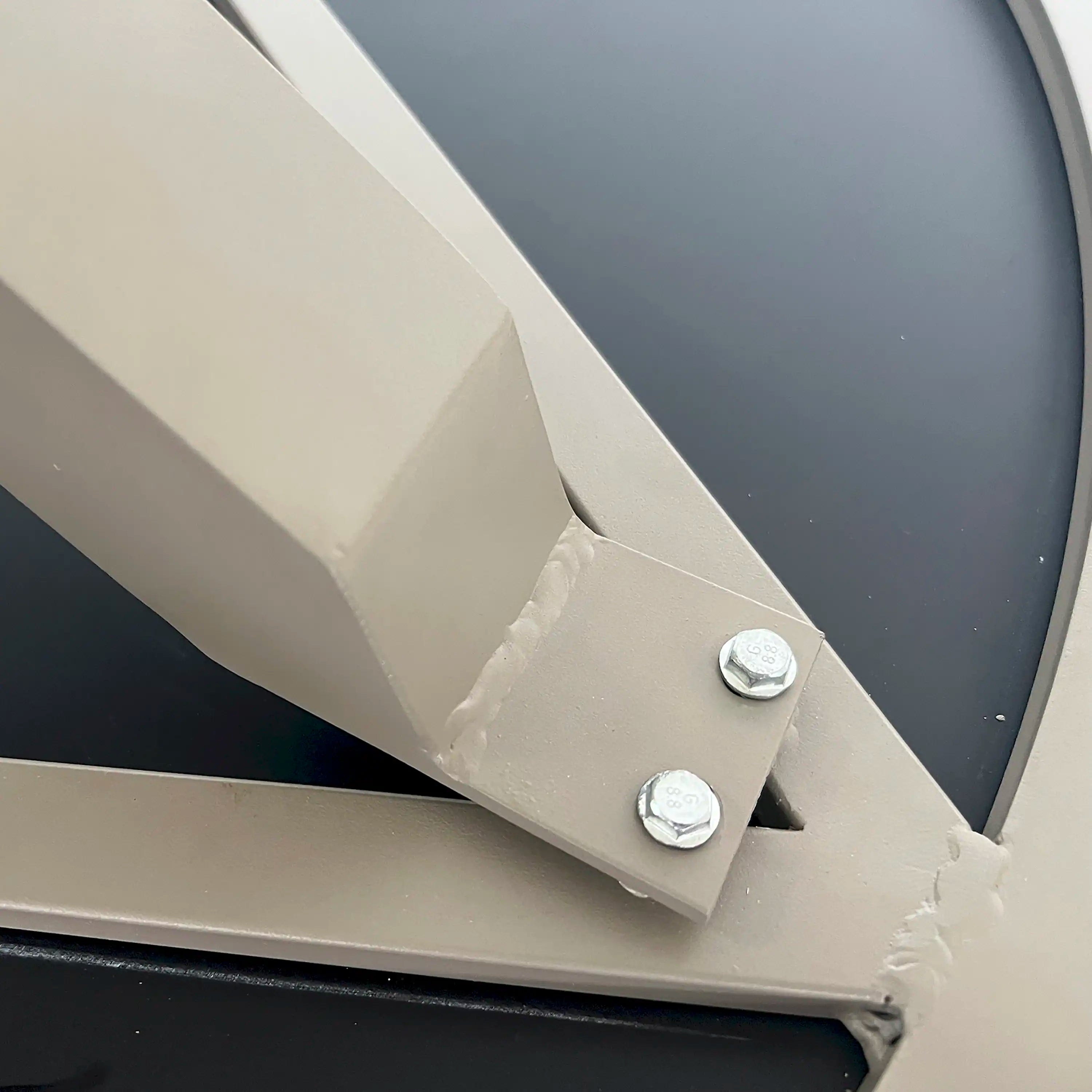 Patio table leg bracket with screws securing the cross support