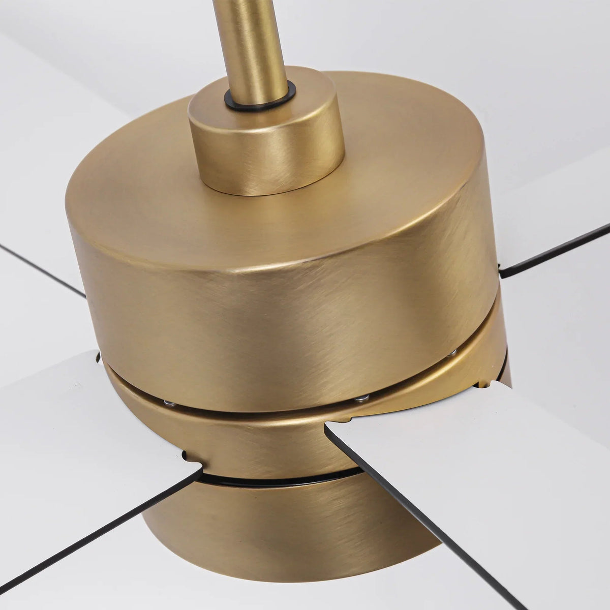 Golden ceiling fan motor housing with central downrod and blade tips