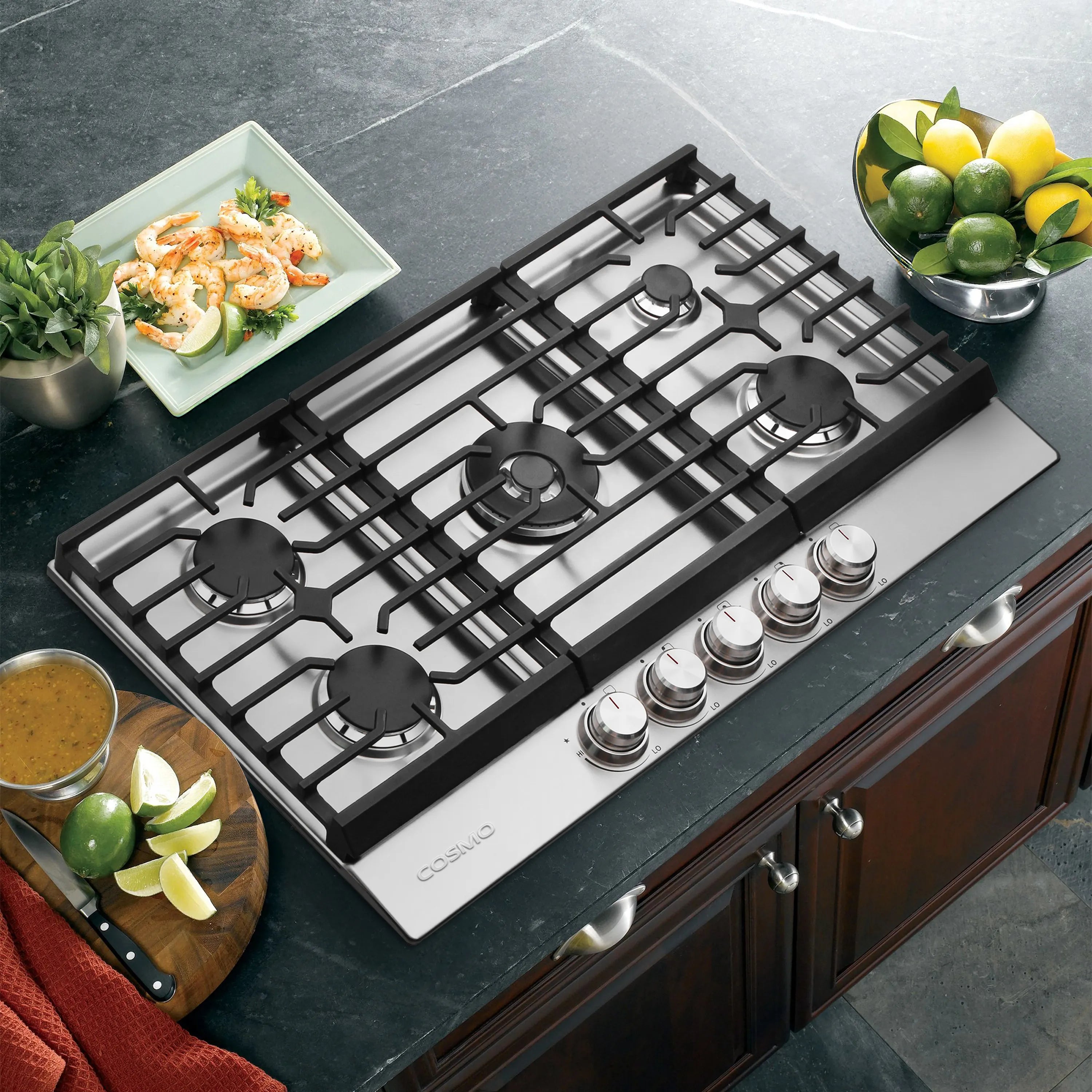 Stainless steel gas cooktop with black grates and control knobs, 5 burners