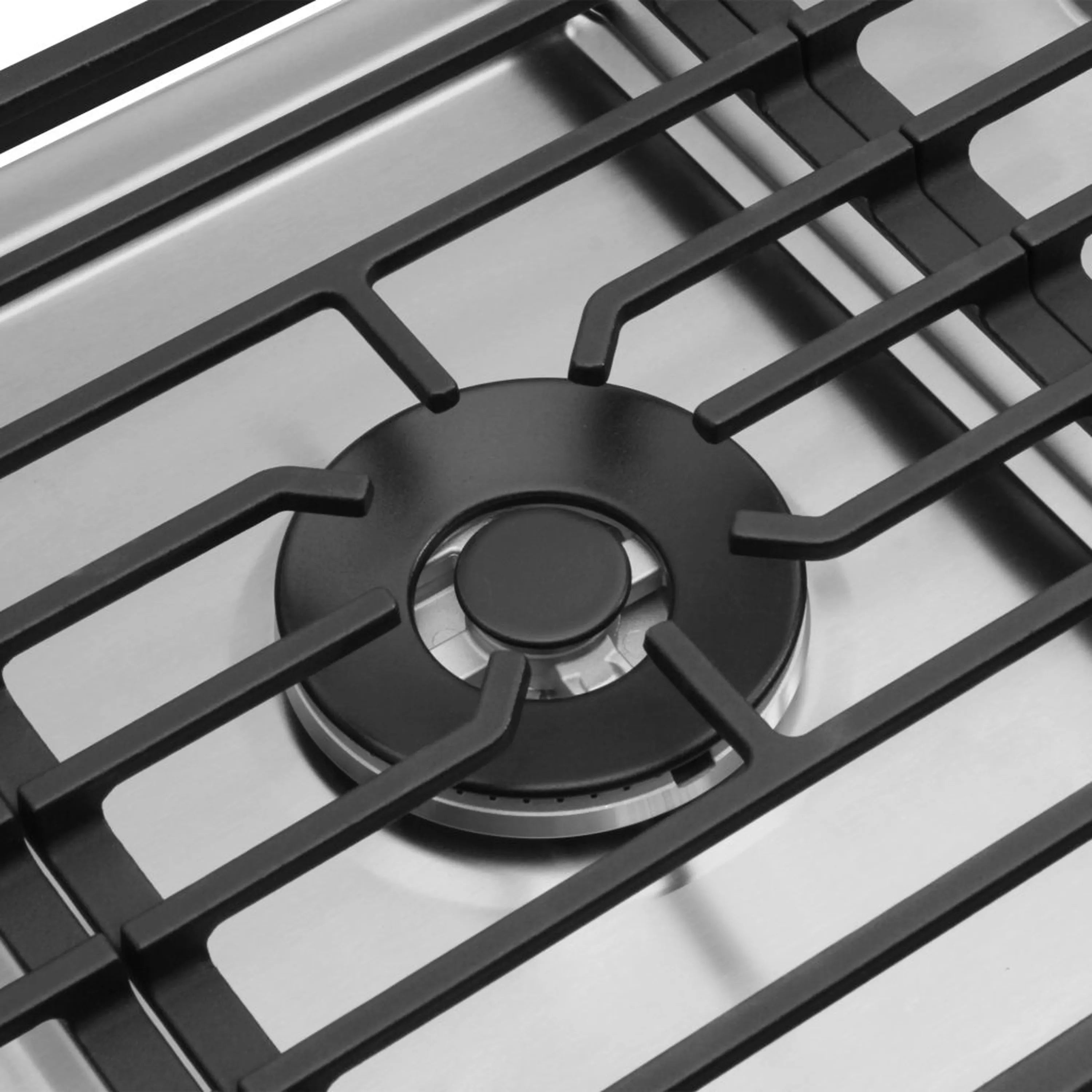 Gas cooktop burner close-up with black grate and circular burner head