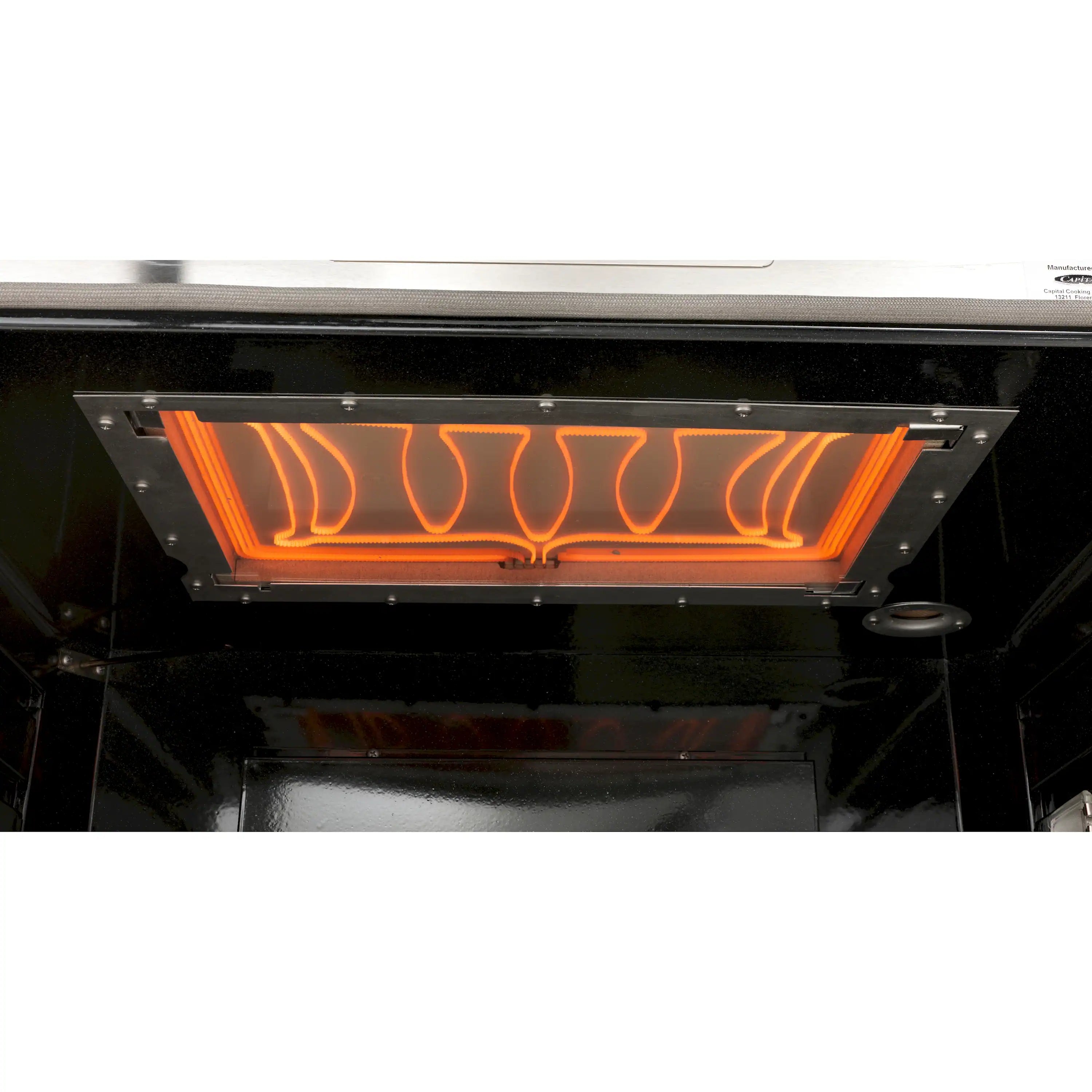 Oven broiler heating element glowing orange through the oven window