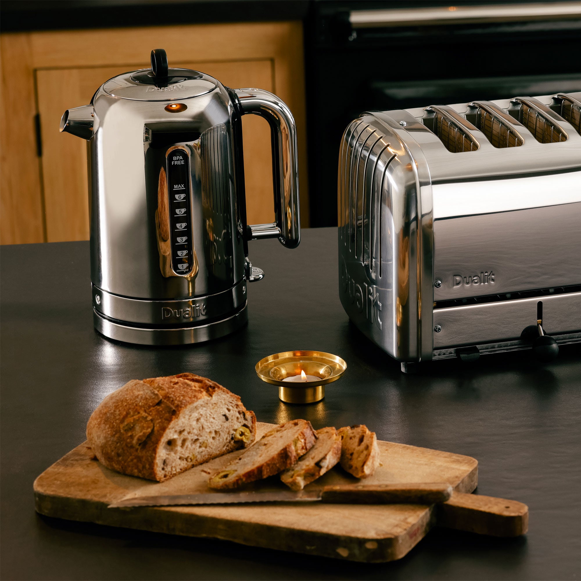 Polished chrome electric kettle with spout and handle, beside polished chrome toaster.