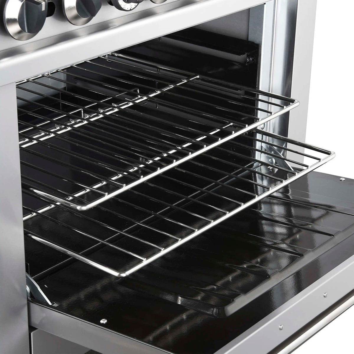 Stainless steel oven interior with black cooking surface and chrome wire oven racks